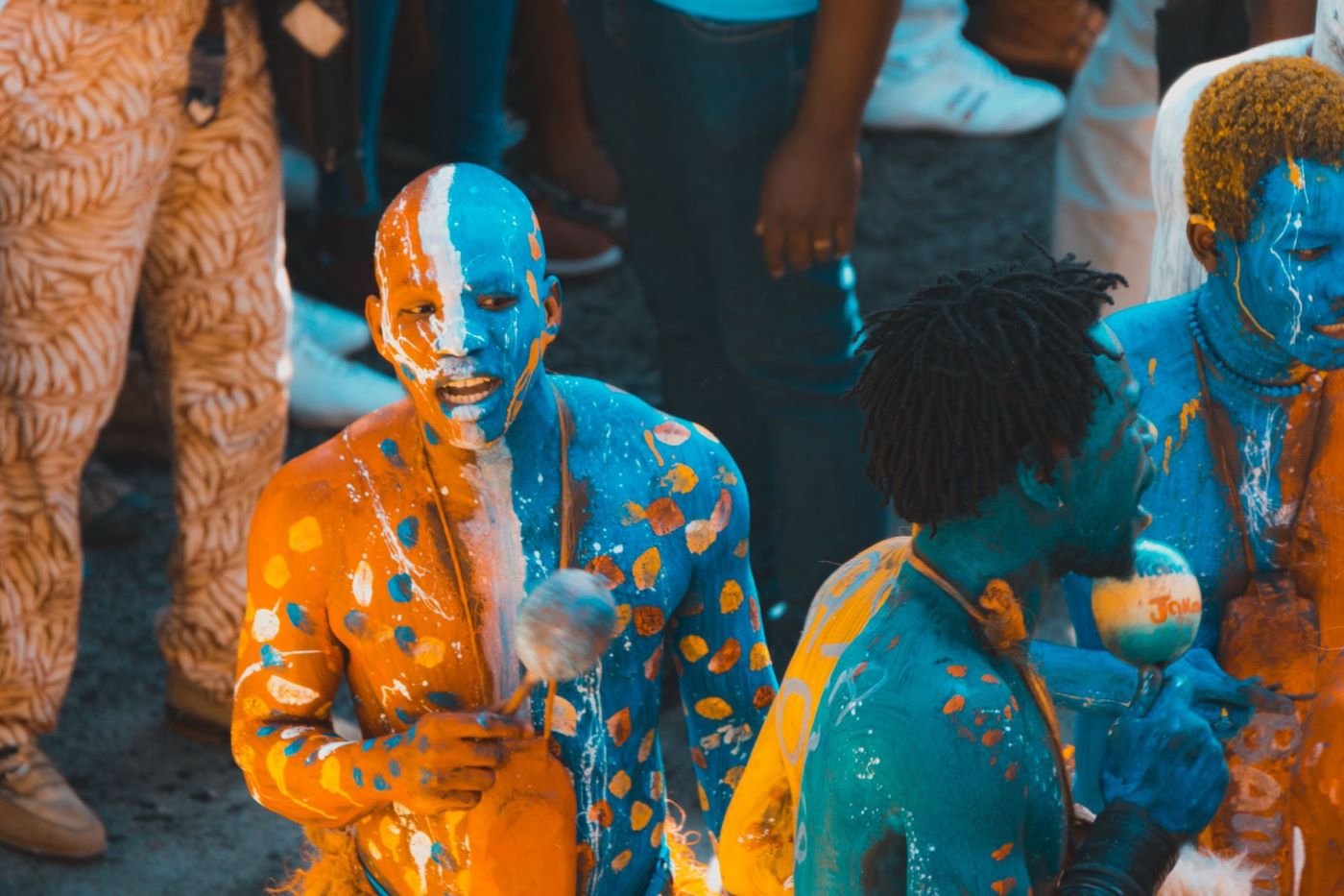 Haitian Carnival revellers in blue and orange paint