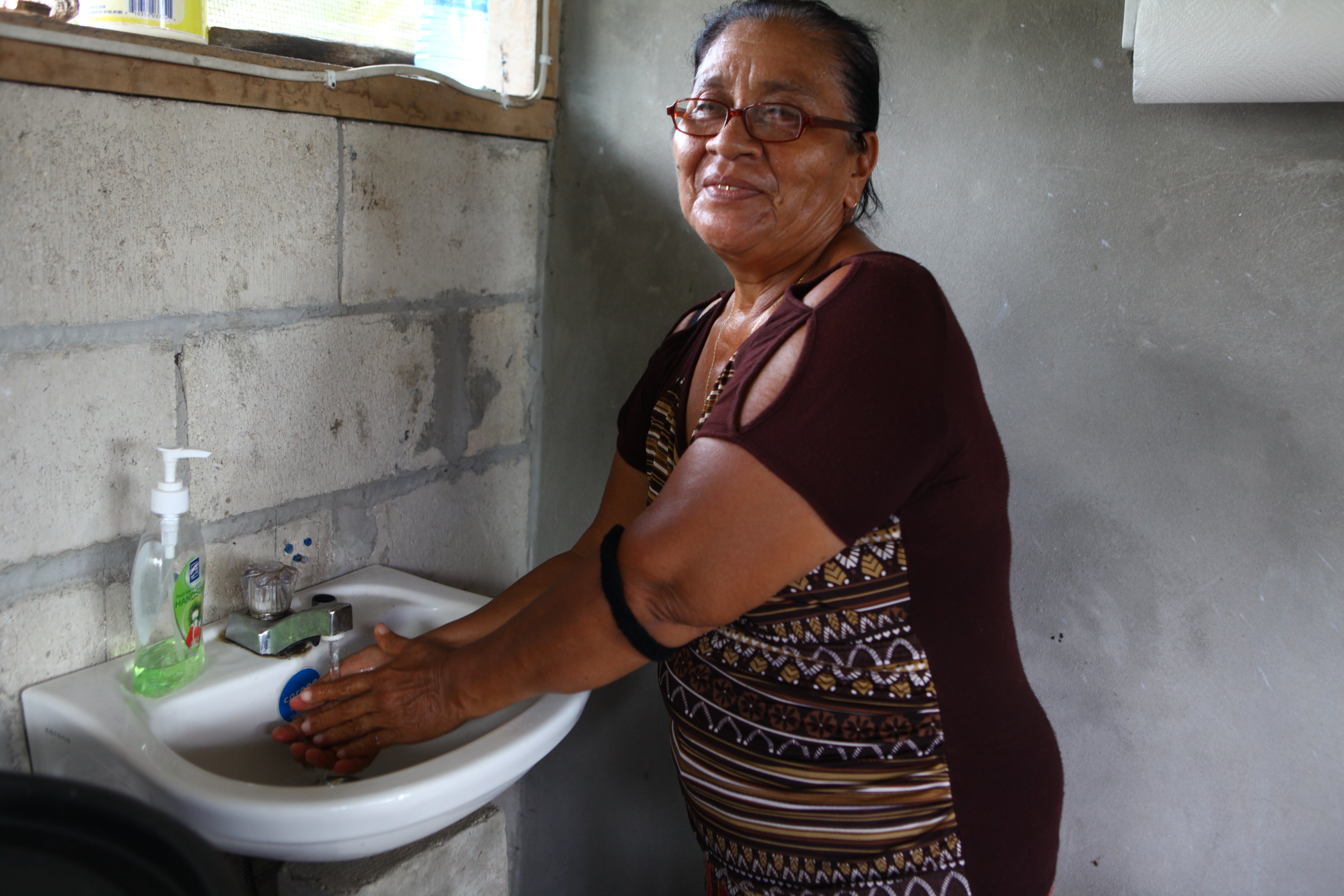 Juanita Banner washes her hands at home