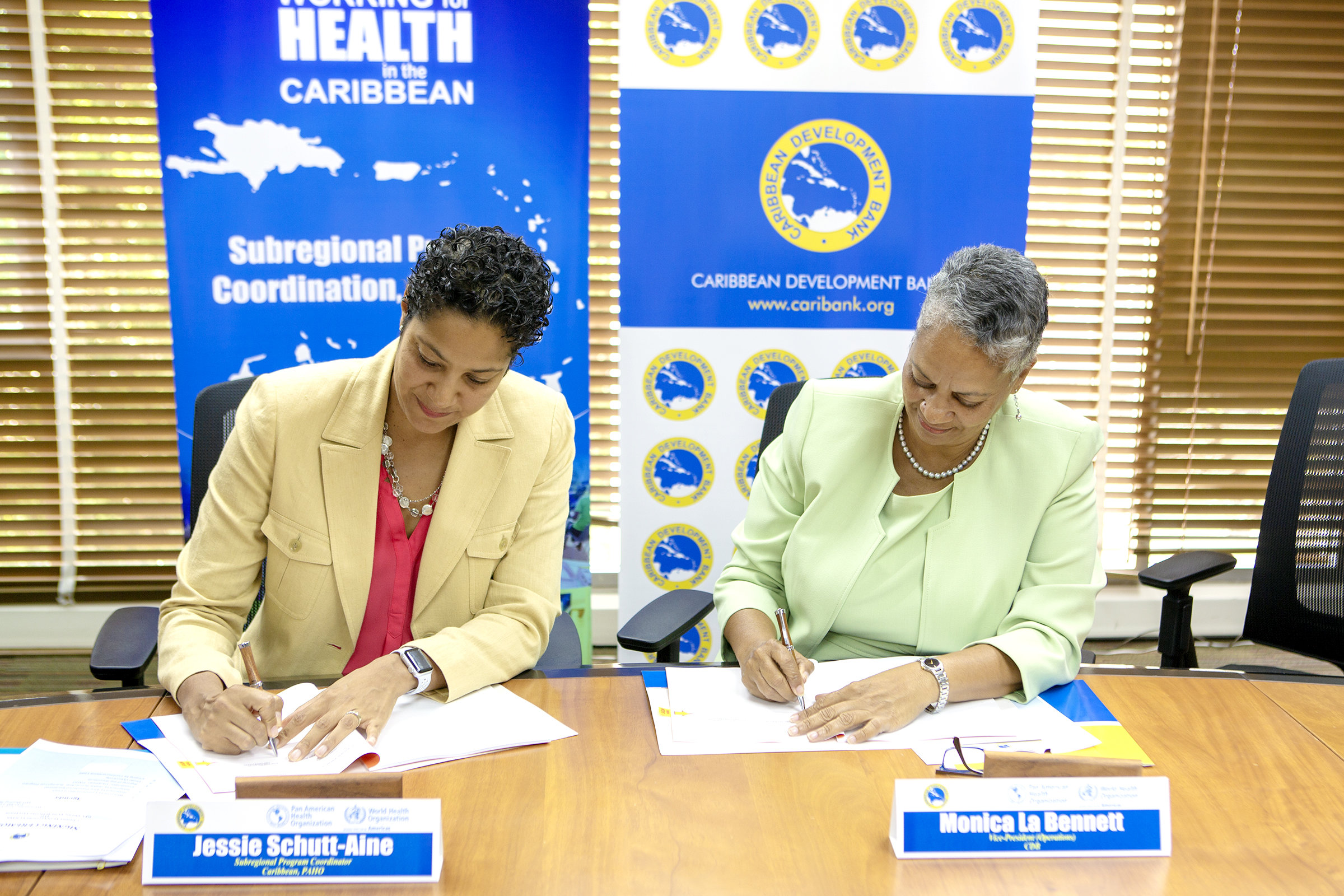 Jesse Schutt Aine (left), Subregional Program Coordinator, Caribbean, PAHO and Monica La Bennett (right), Vice-President (Operations), CDB, sign the agreement to enhance capacity for mental health and psychosocial support in disaster management in the Caribbean. The signing took place on June 13, 2018, at CDB’s headquarters in Barbados.