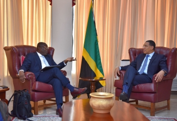 CDB Vice President of Operations and Jamaica Prime Minister seated in armchairs having a discussion