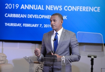 Daniel Best in a blue suit standing at the lectern delivering his remarks at the Annual News Conference