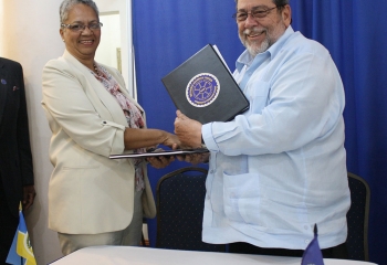 CDB Vice-President Monica La Bennett and Chairman of the RSS Council of Ministers, St. Vincent and the Grenadines Prime Minister, Hon. Dr. Ralph Gonsalves shake hands after signing the grant agreement between CDB and the RSS.