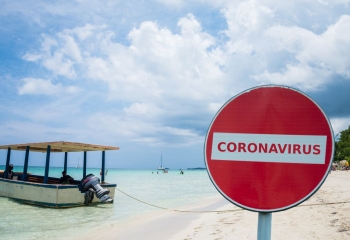 Coronavirus no-entry sign in front of a beach, Negril, Jamaica