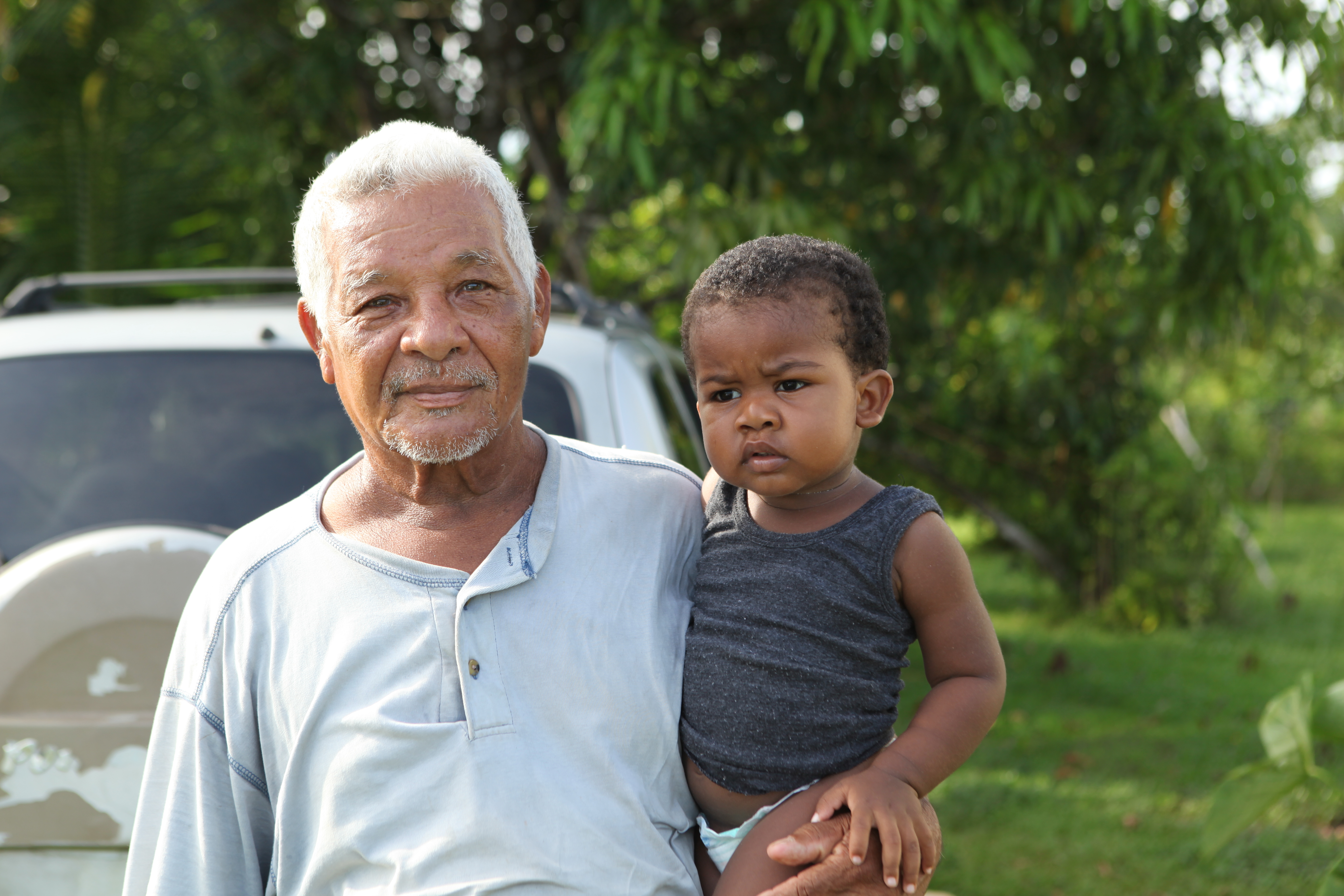 Senior holding a small child