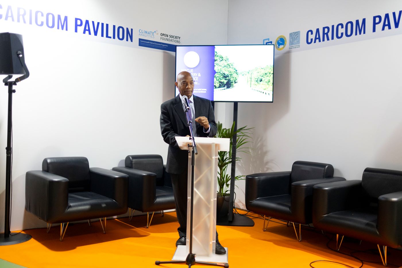 CDB President Dr Gene Leon at lectern at COP 26