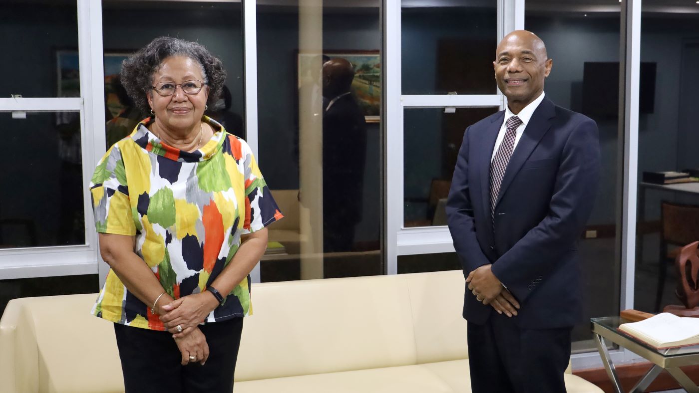 Dr Carla Barnett in multicoloured blouse and black slacks next to Dr Gene Leon in dark suit and tie