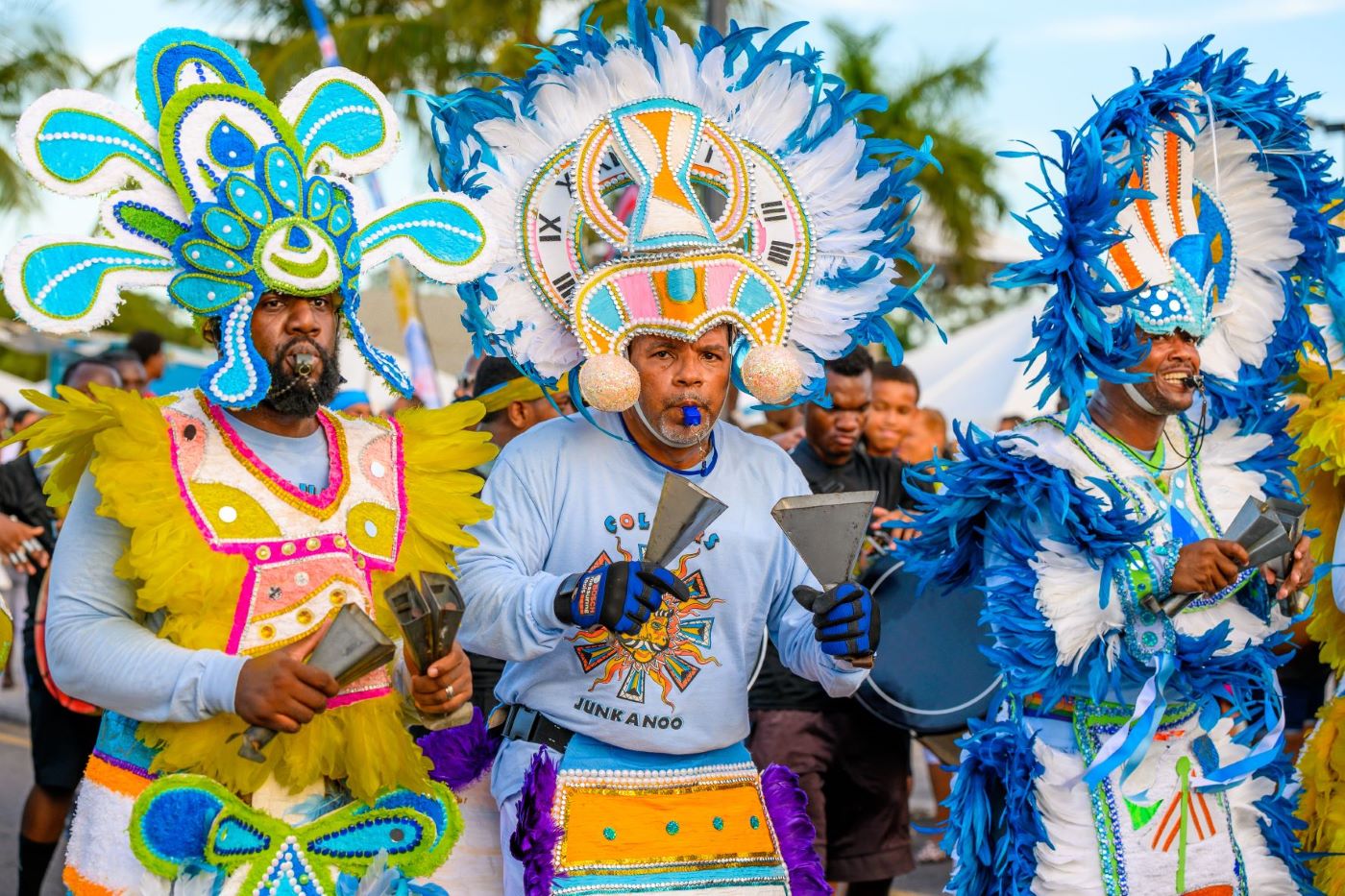 Three men in Bahamas Junkanoo costumes playing music