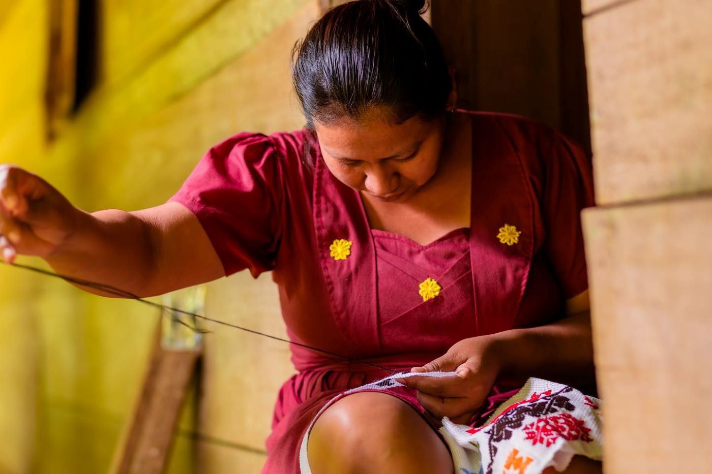 Mayan woman working on embroidery