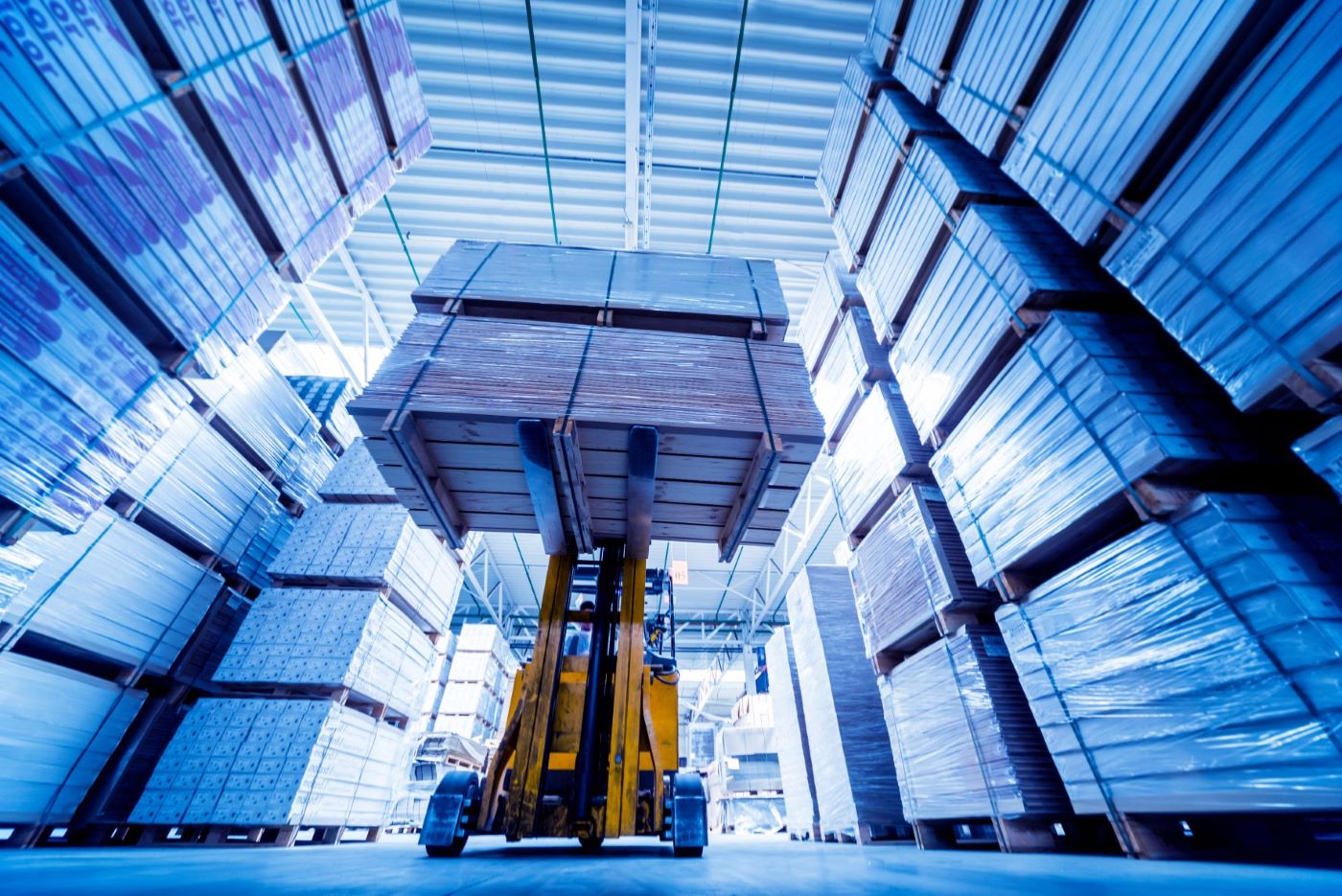 forklift lifting boxes in warehouse