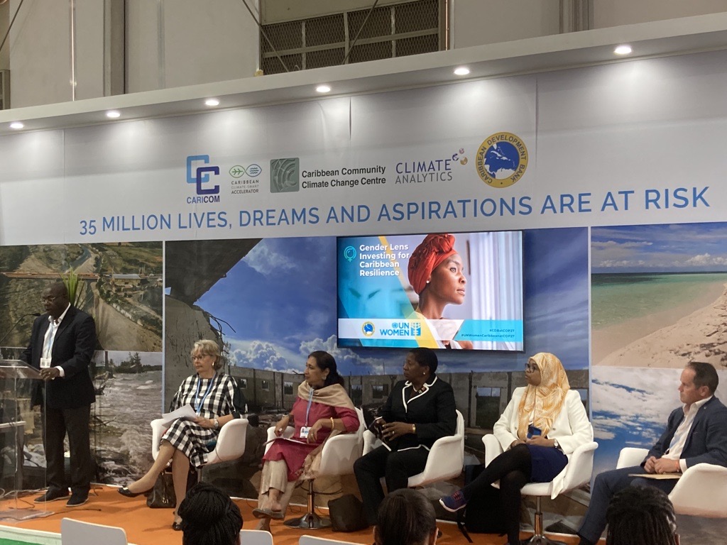Row of speakers seated in CARICOM pavilion at COP 27