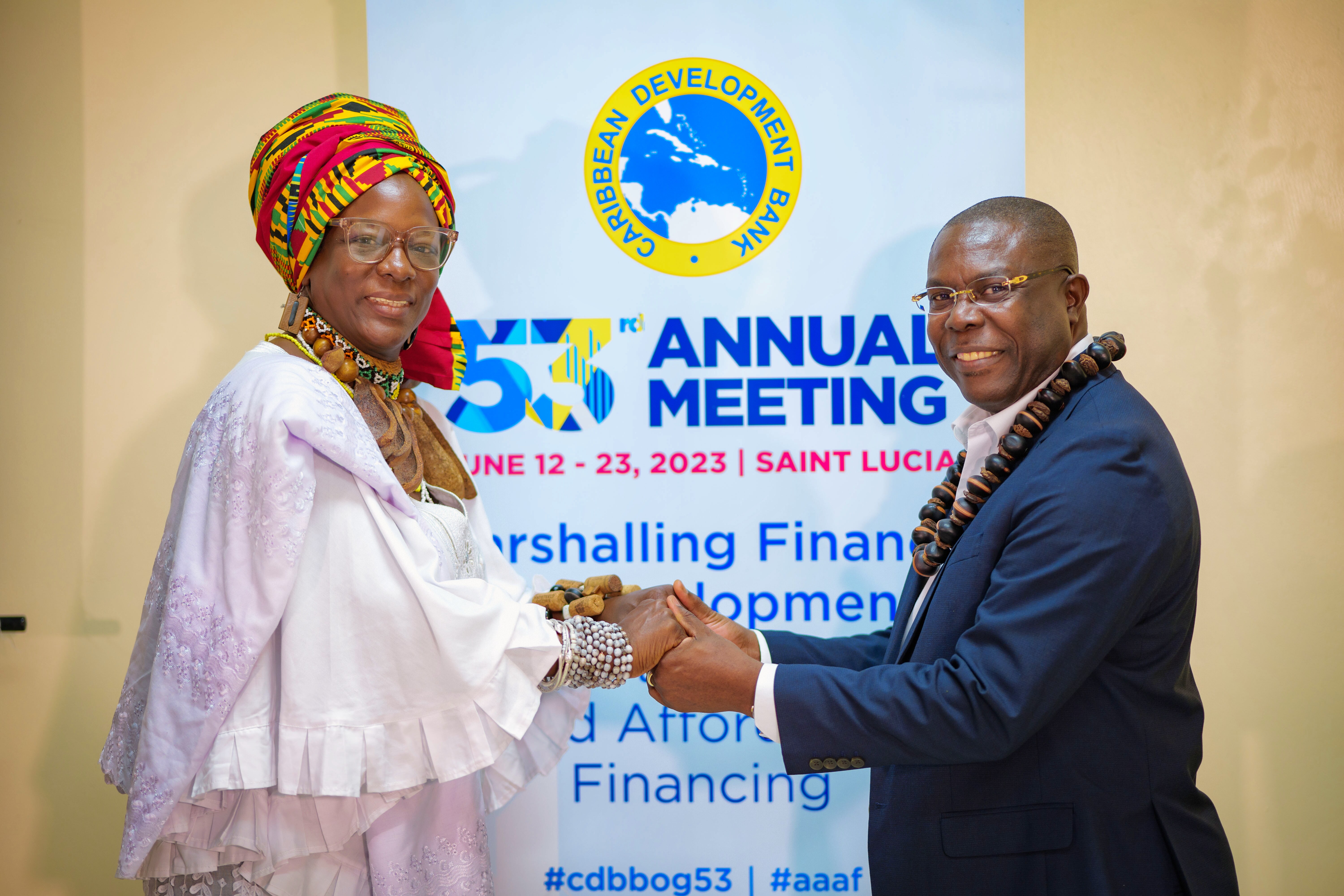 male and female standing in front of CDB banner