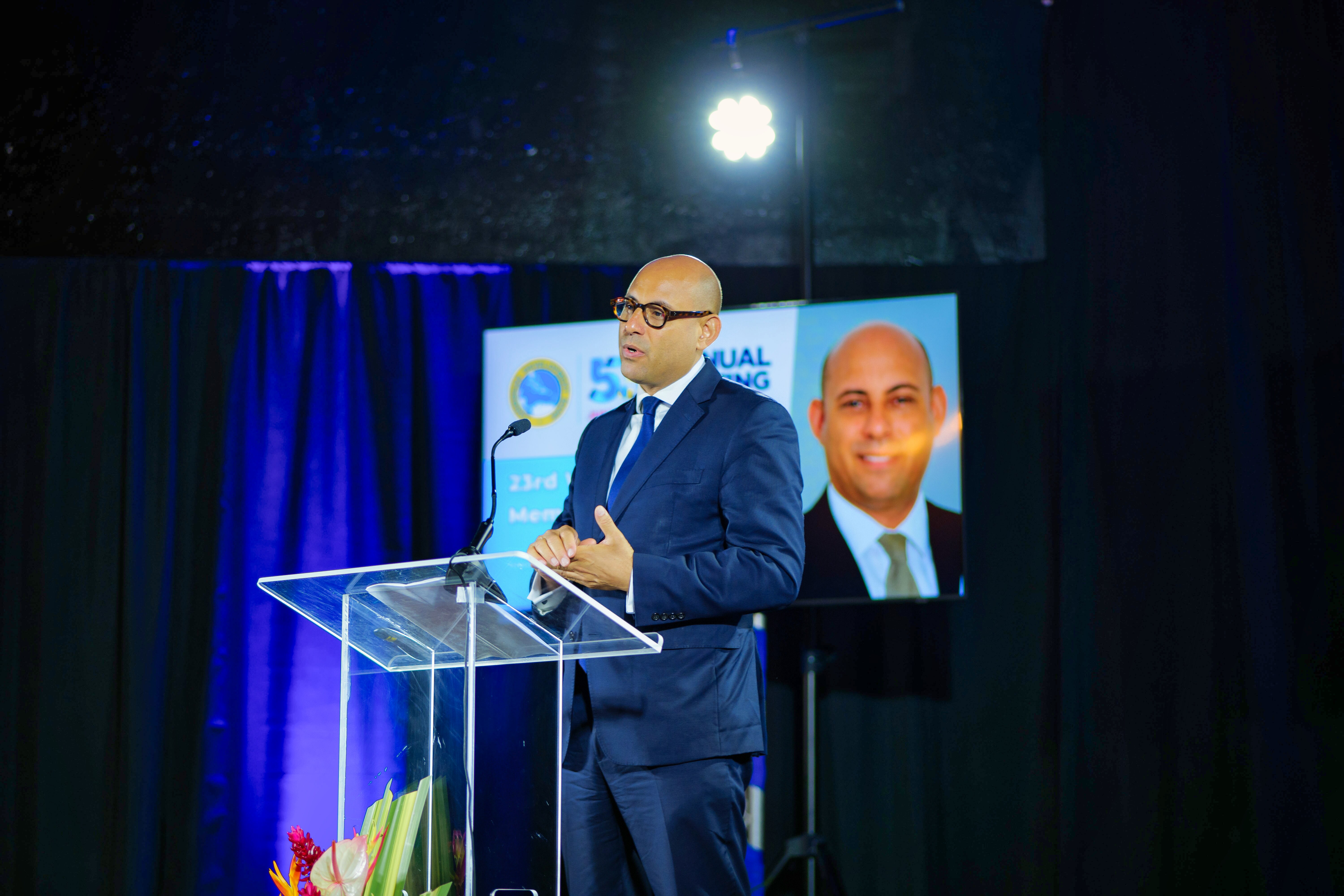 man standing at lectern delivering remarks