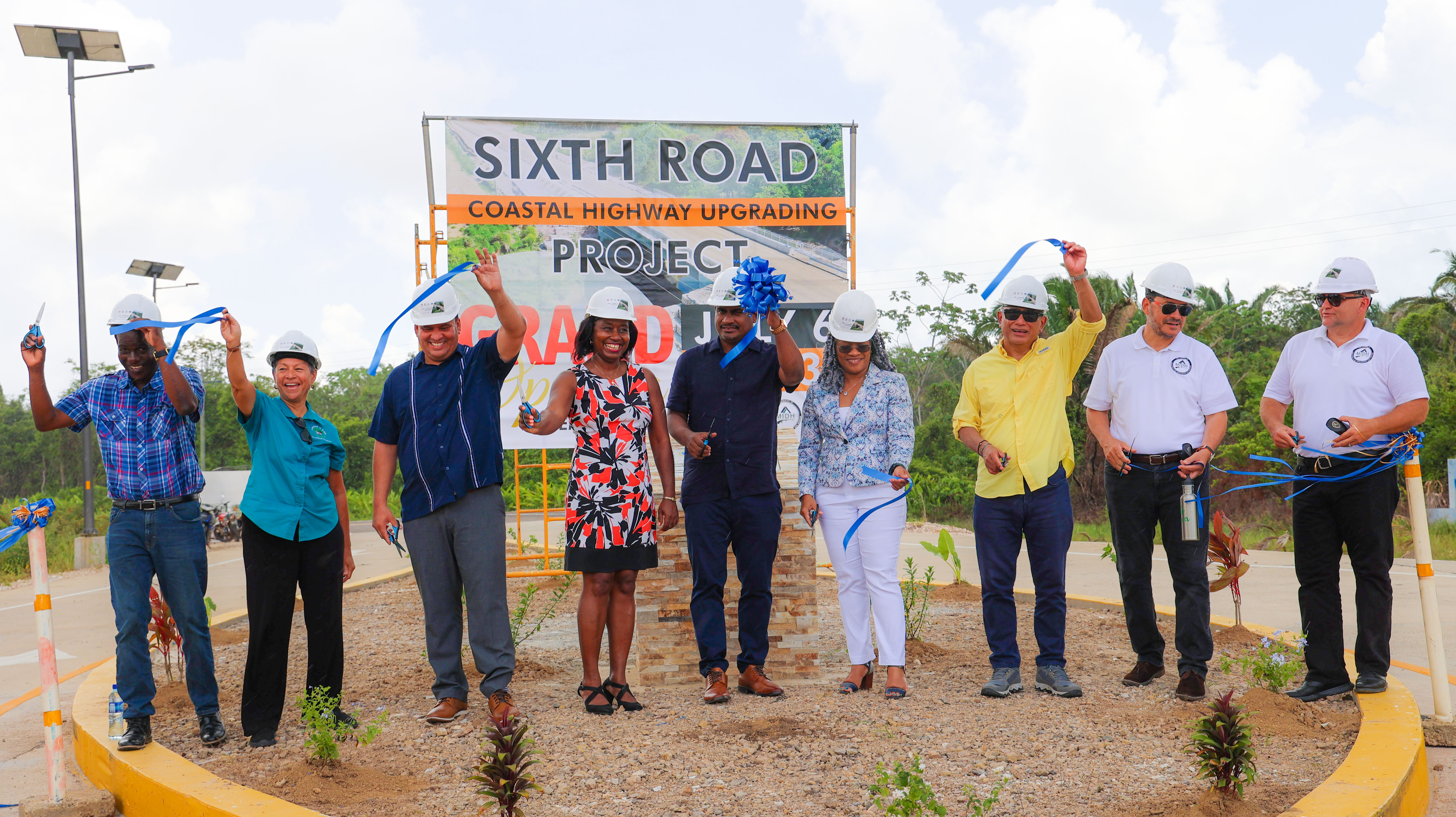 group photo of stakeholders standing on upgraded coastal highway