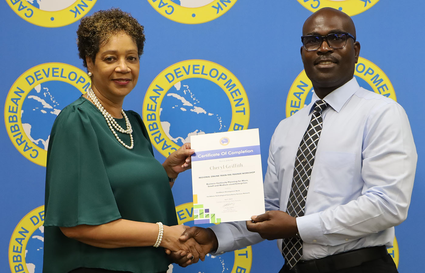 smiling female accepting certification for completion of a course