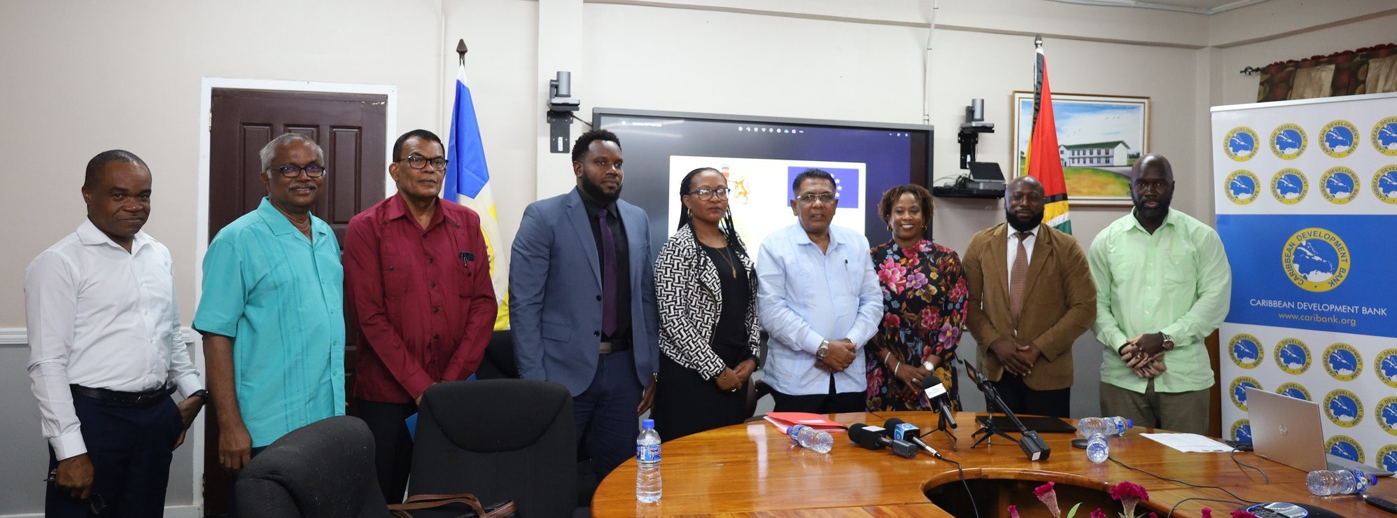 Cross section of CDB and Government of Guyana Representatives standing at project launch event 