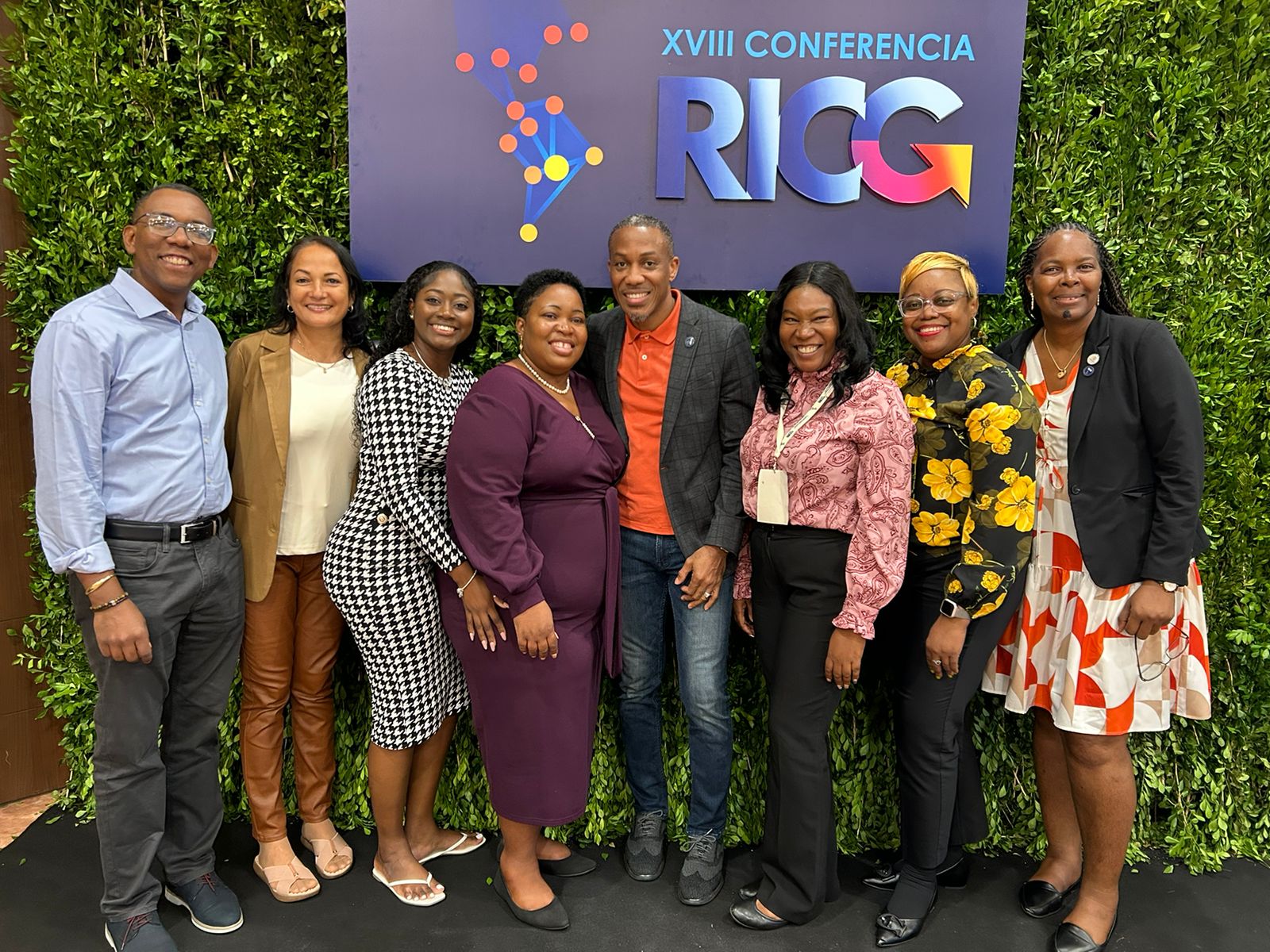 a group of males and females standing in front of a backdrop with INGP branding