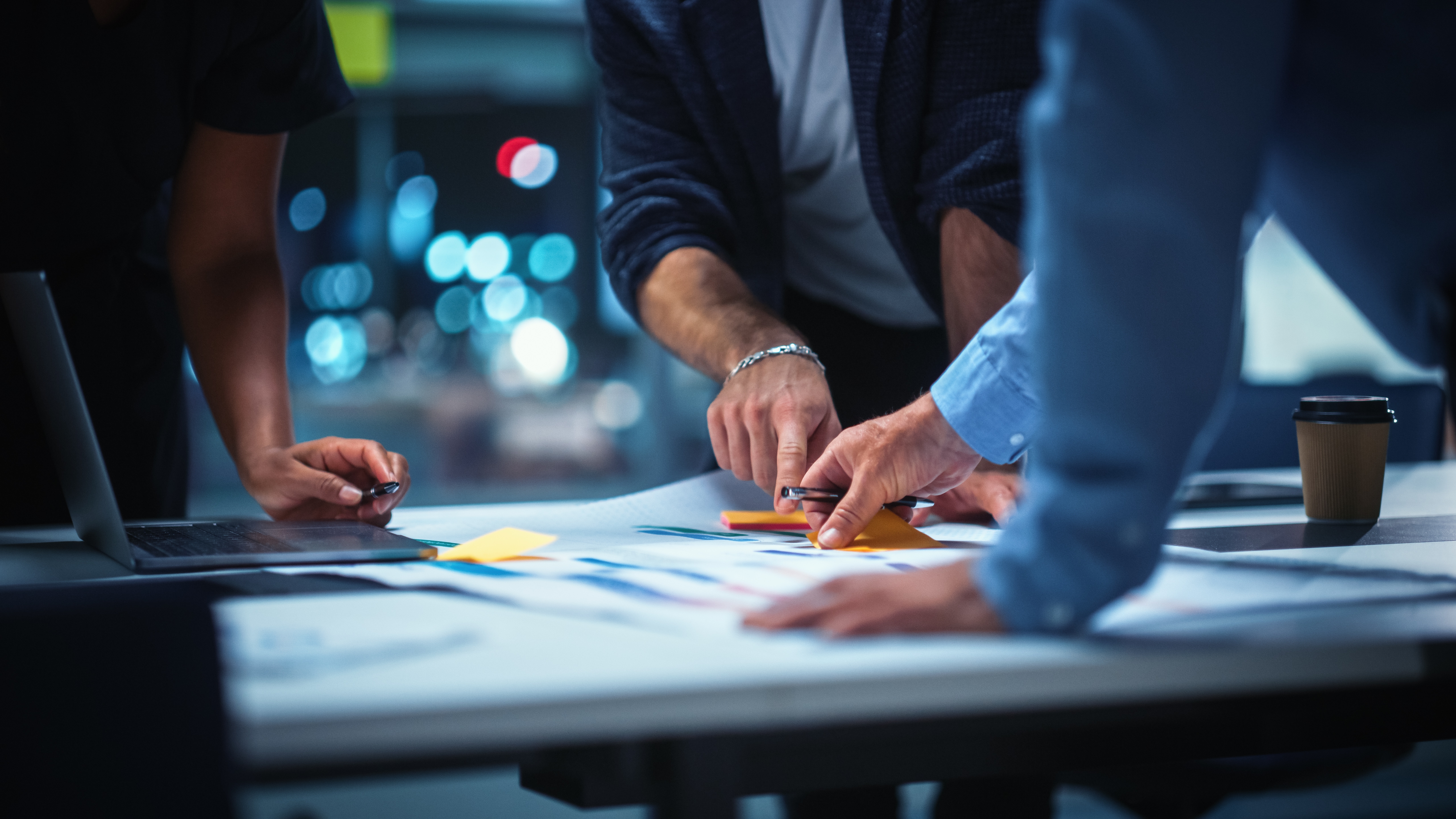 Hands of a Diverse Team of Top Managers Talking and Brainstorming