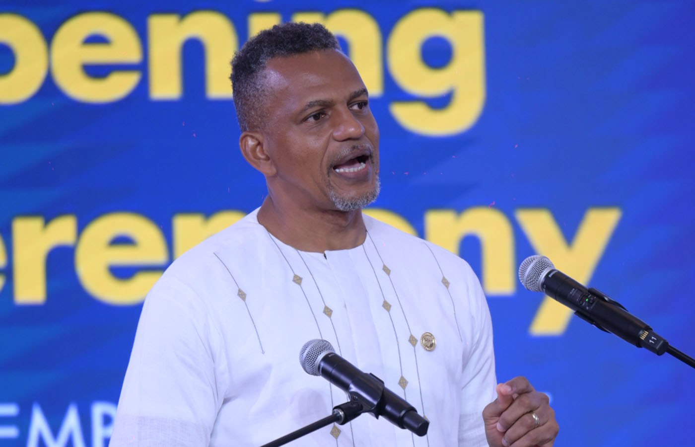 Caribbean Development Bank President Daniel M. Best delivering opening remarks at the 2025 Regional Symposium on Transforming Education, standing at a podium with microphones