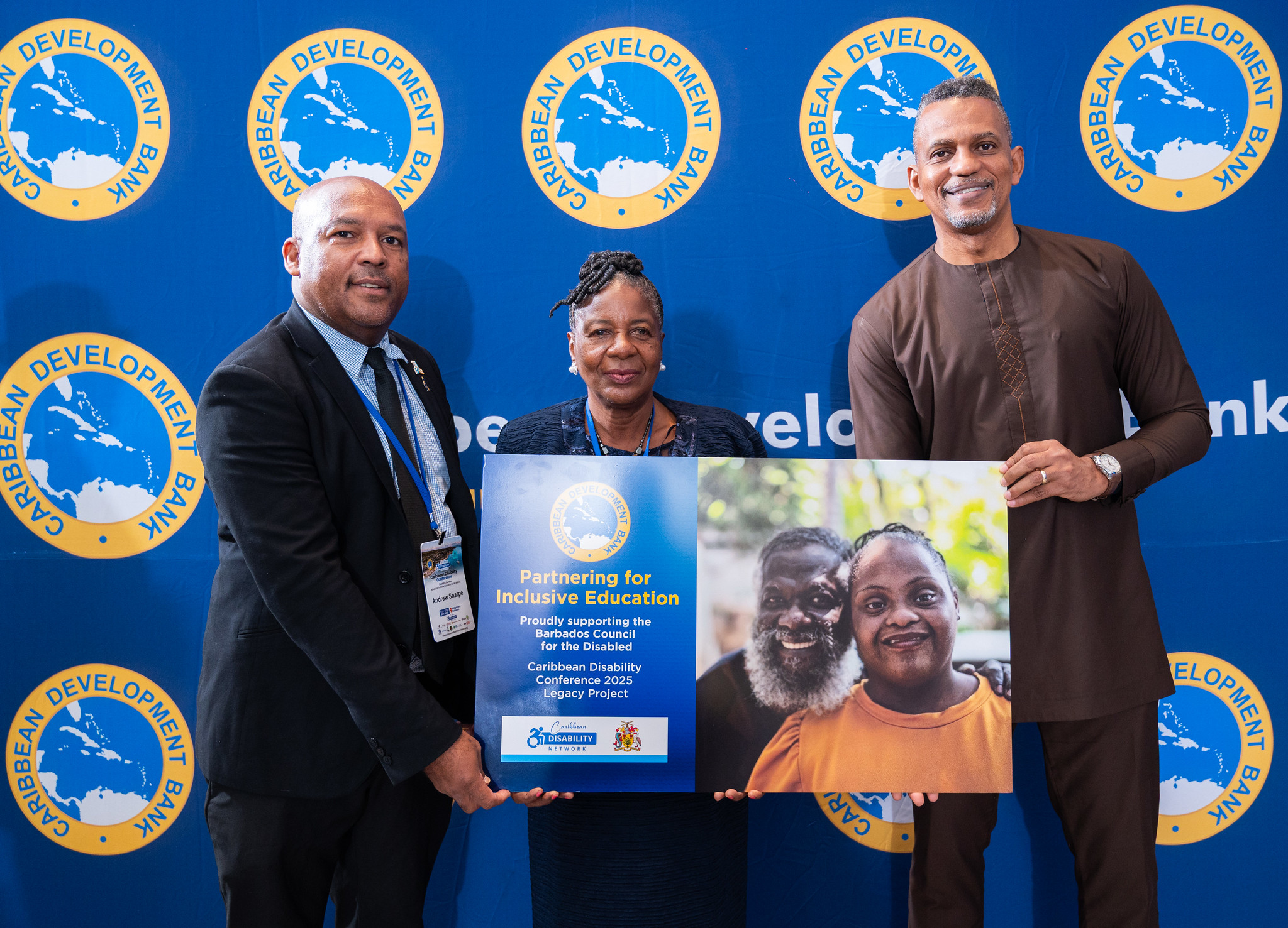 Caribbean Development Bank (CDB) President Daniel Best (right) presents a signboard confirming CDB’s support for the Caribbean Disability Network (CDN) Legacy Project in Barbados to CDN President Andrew Sharpe (left) and Barbados Council for the Disabled President Patricia Padmore-Blackman (centre).