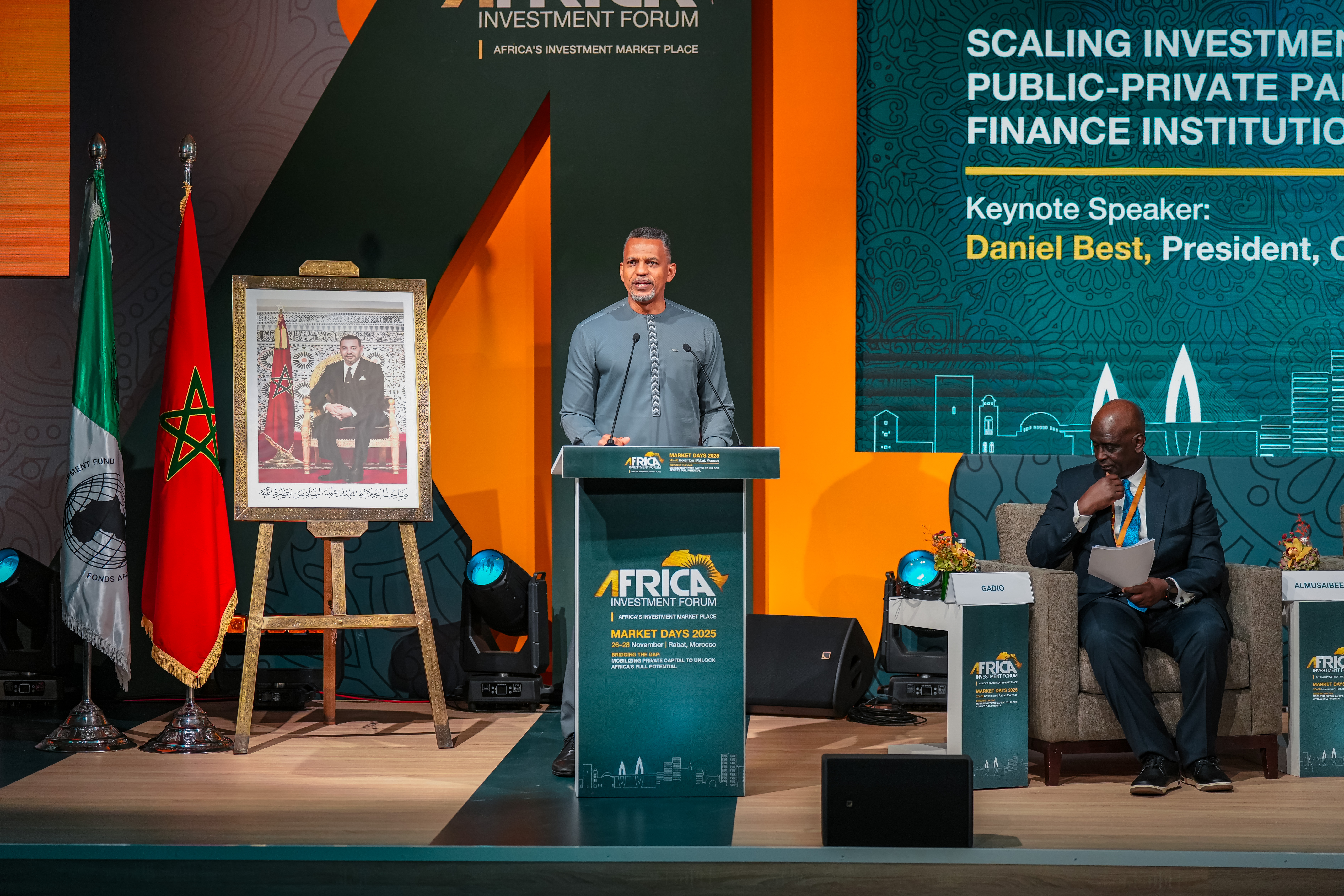 CDB President Daniel Best standing in light grey formal attire at lectern looking straight ahead delivering remarks