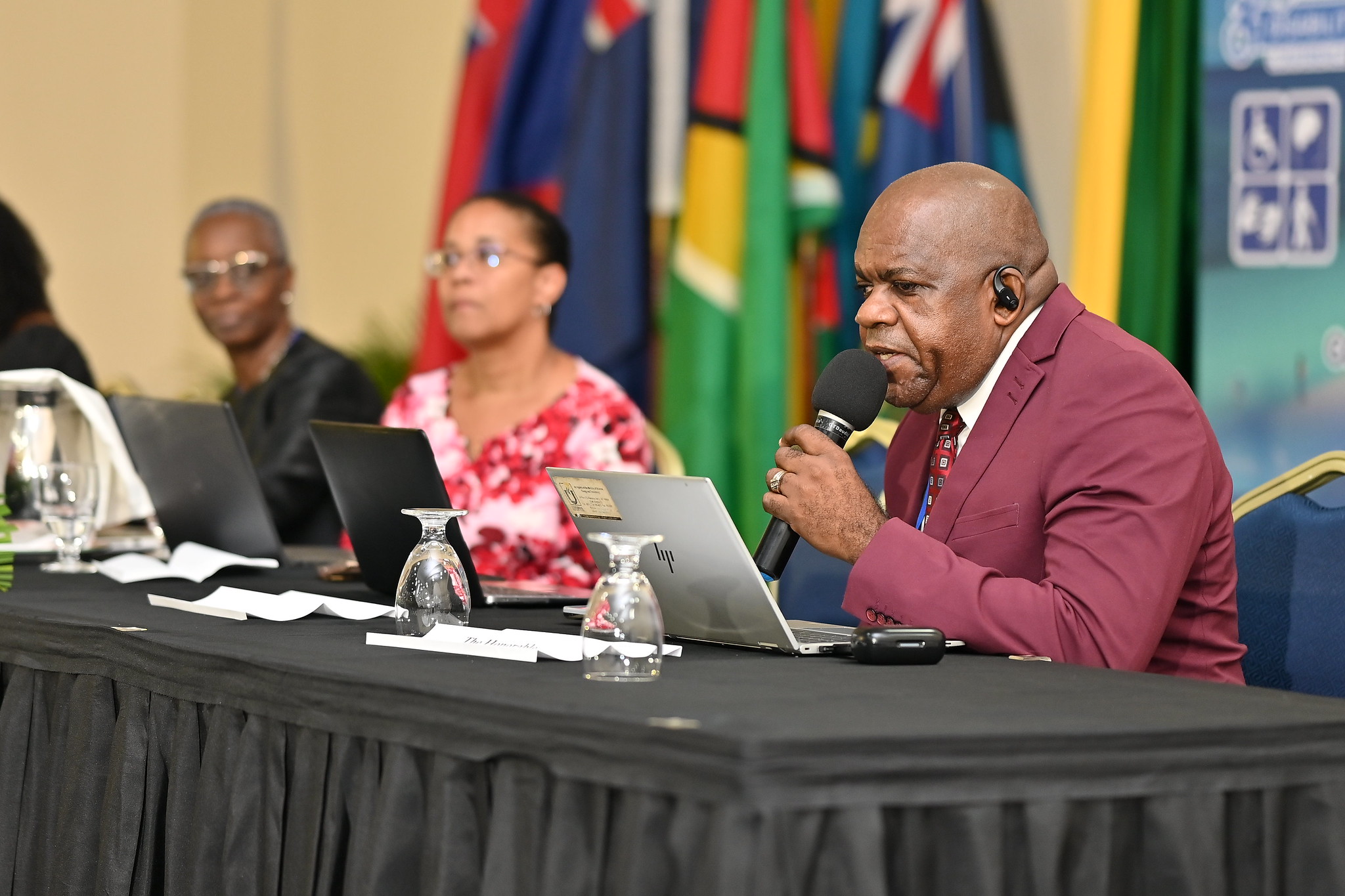 Head table with visually impaired speaker and two others. 