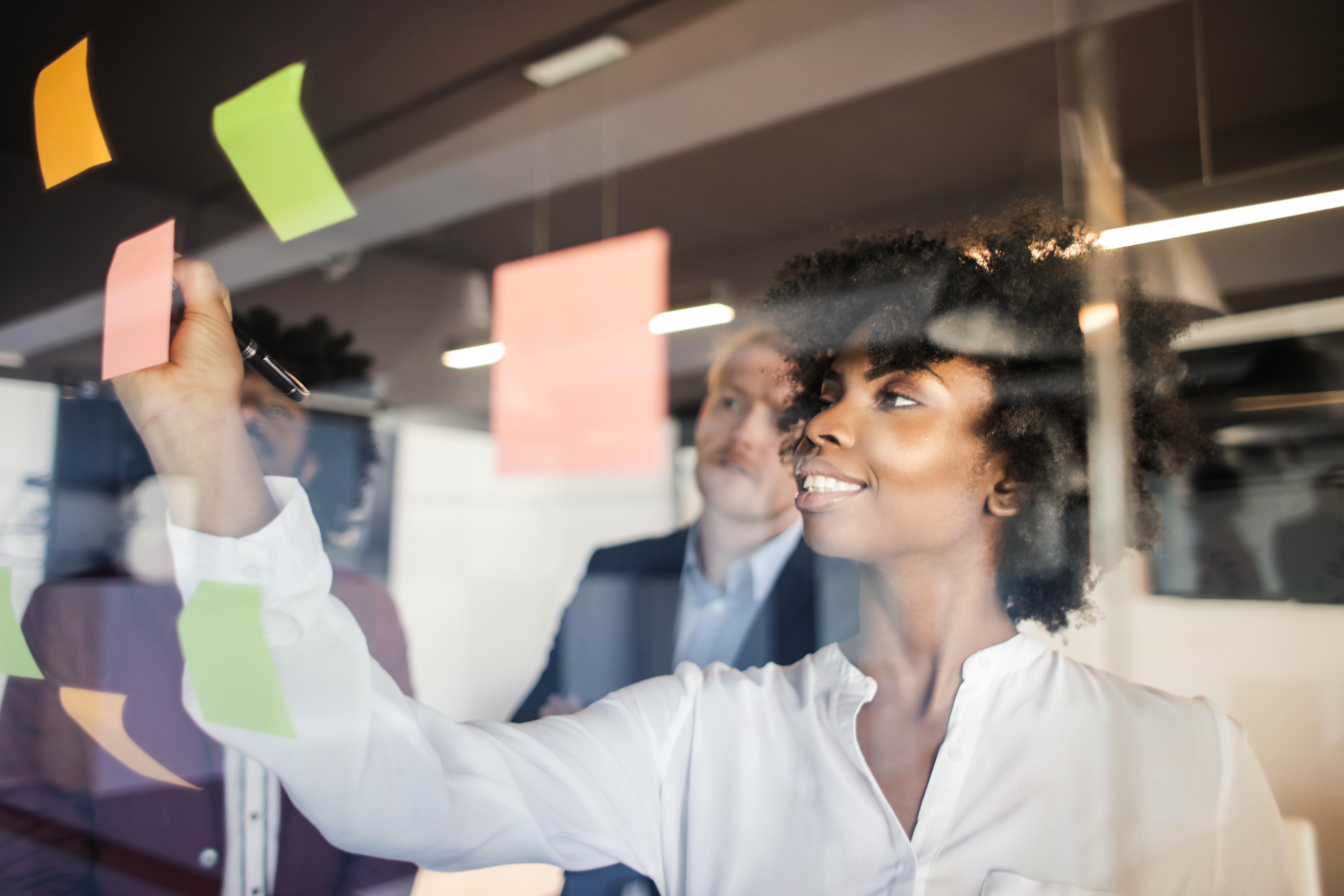 Woman writing in sticky notes