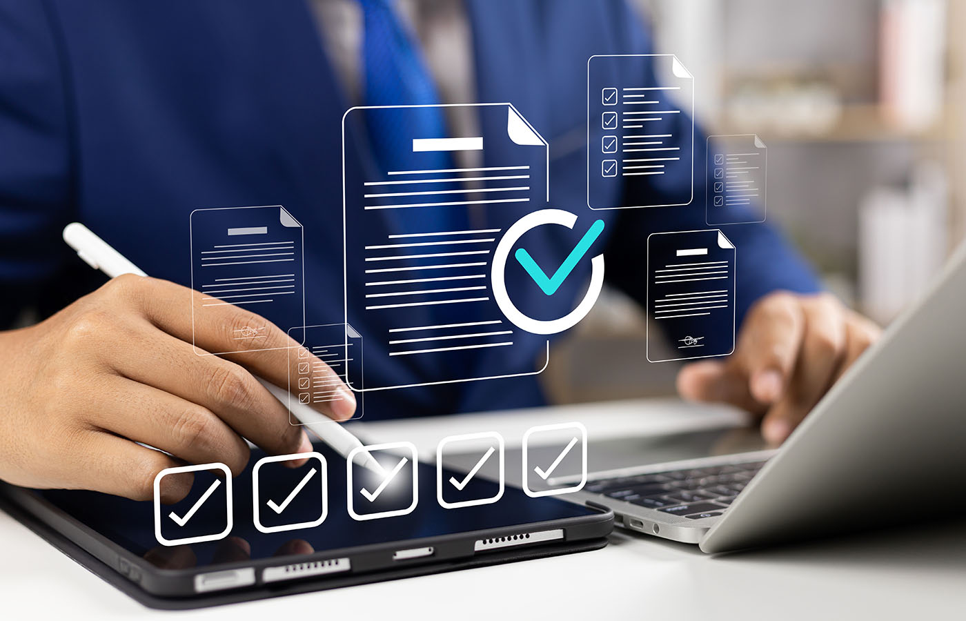Person using a digital tablet and laptop with icons of documents and checkmarks representing online document review.