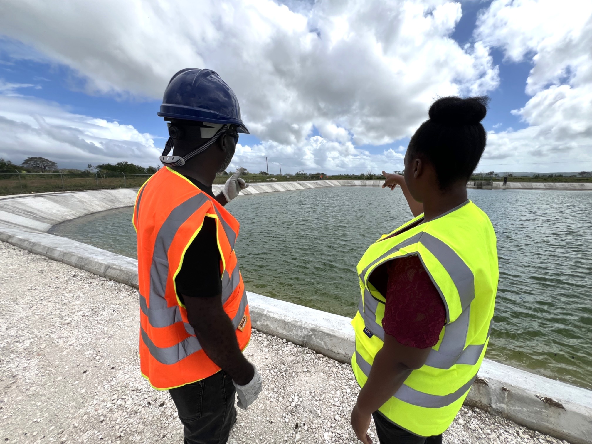Southern Plains Agricultural Development (SPAD) Project team members observe reservoir delivered under the initiative.