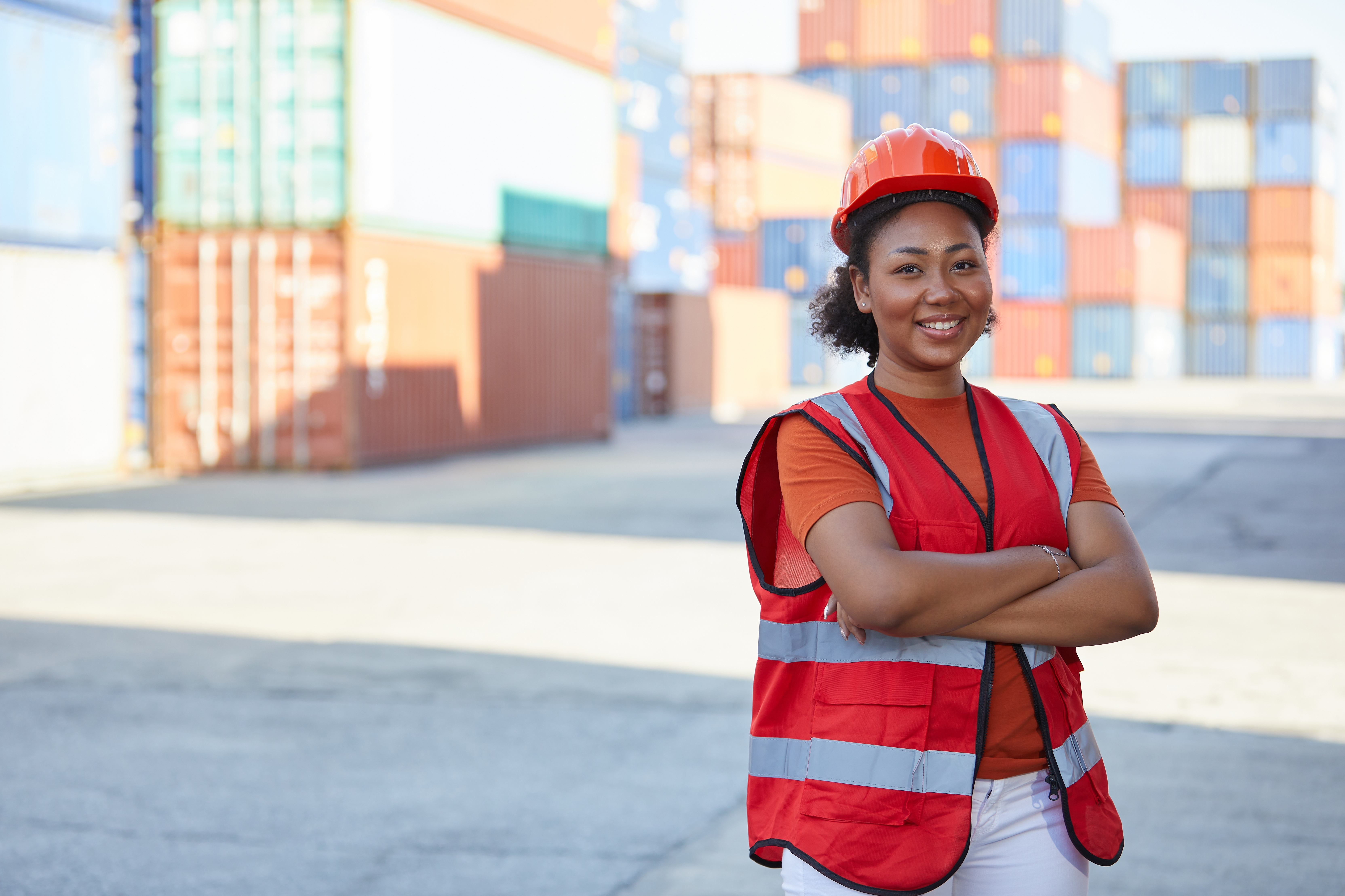 Young female worker smiling in outdoor workplace