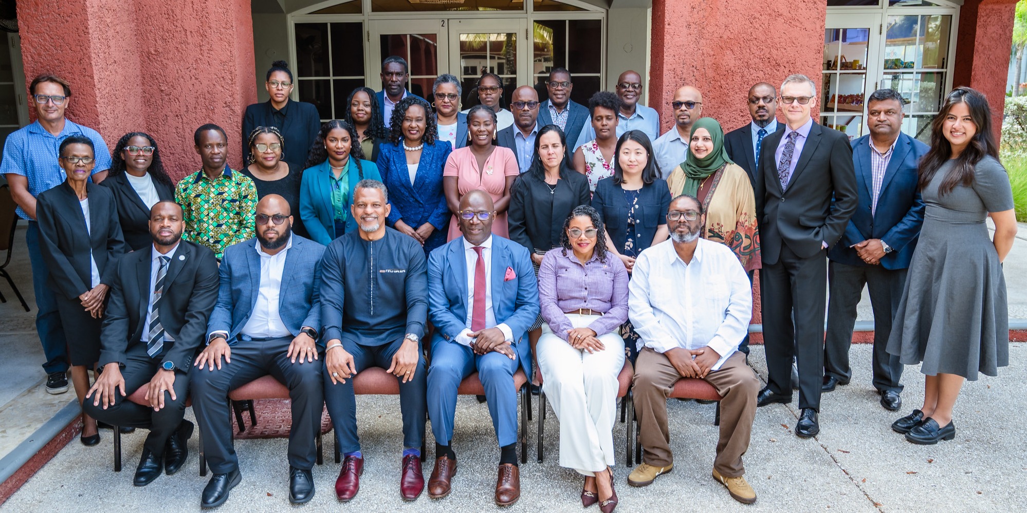 Experts and participants attending the Fund for responding to Loss and Damage (FRLD) workshop pose for a photo outside of the event venue.