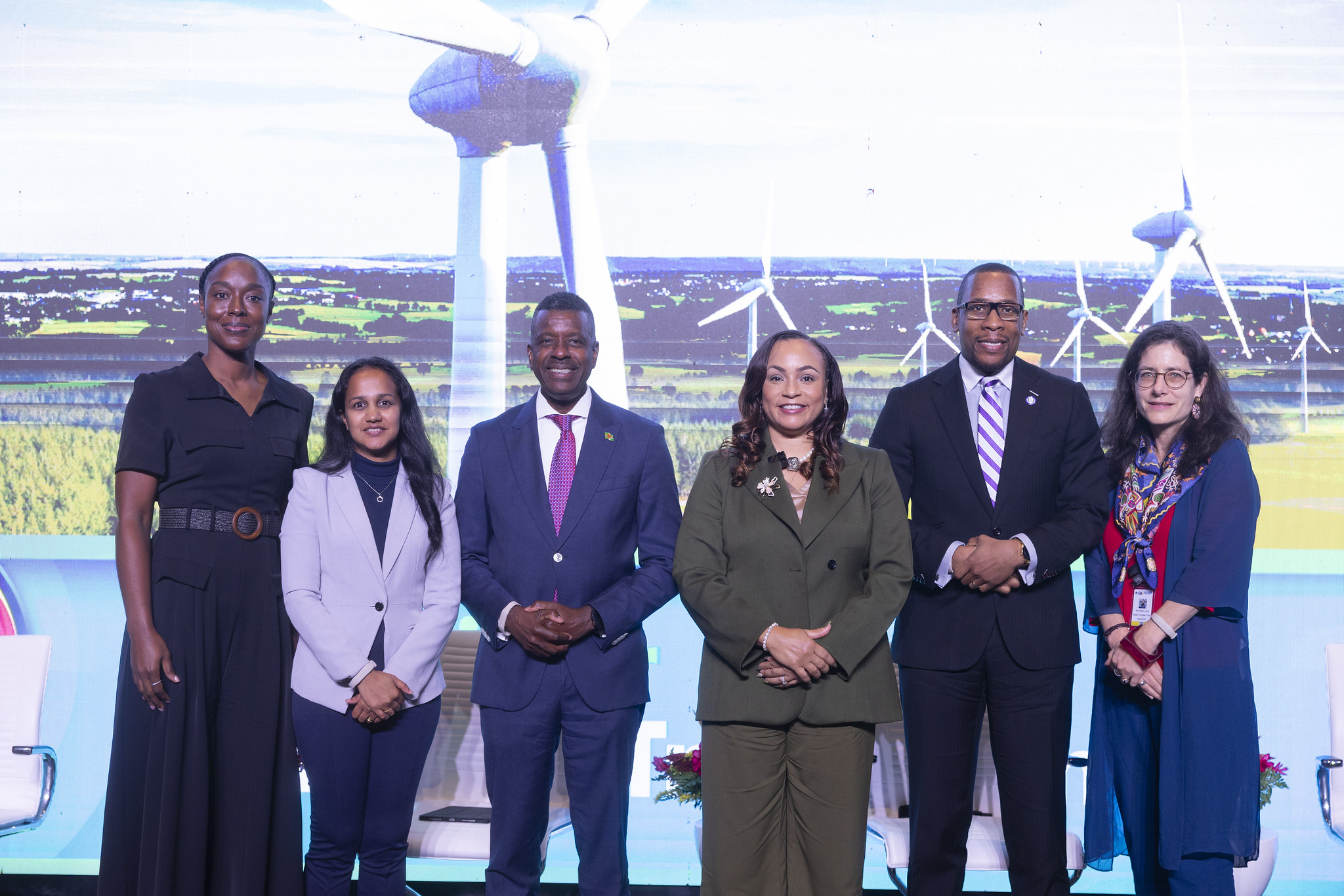 Seminar Panelists for Energy Transition: The Key to a More Resilient Region standing on event stage at Caribbean Development Bank 56th Annual Board of Governors Meeting