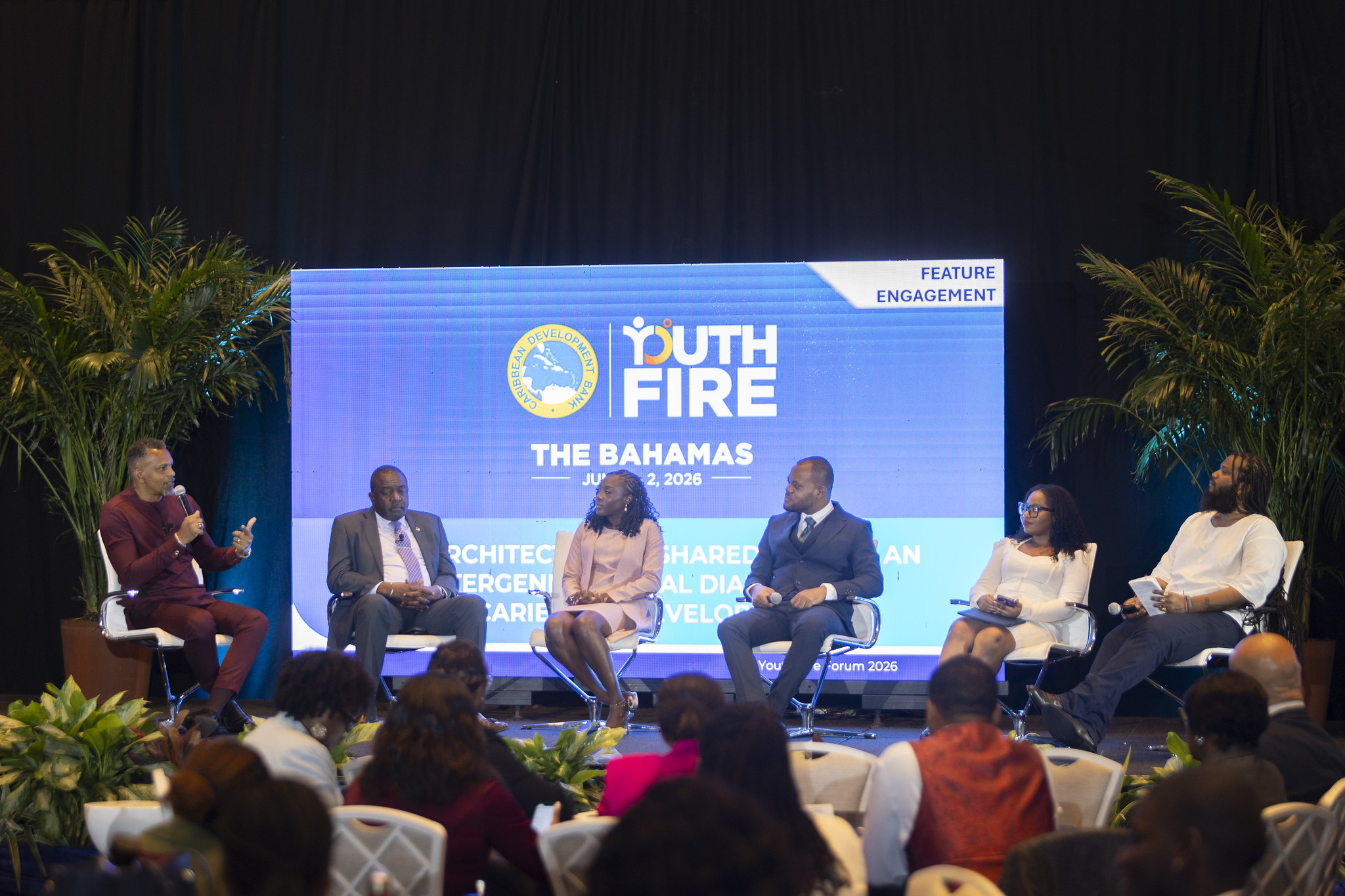 Mr. Daniel Best, President of the Caribbean Development Bank, speaks on stage to other panellists during Youth Fire Forum