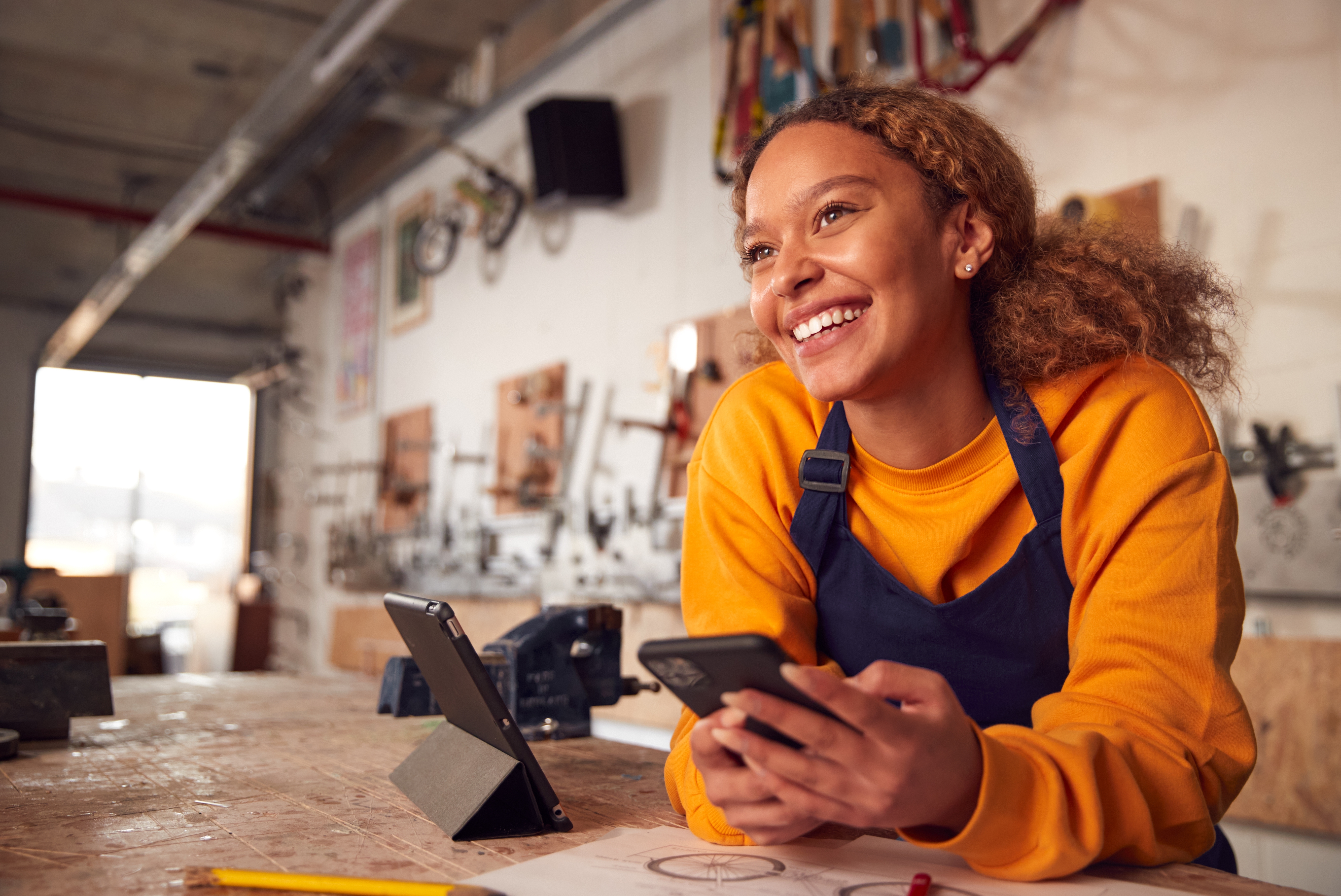 Young woman in workshop smiling