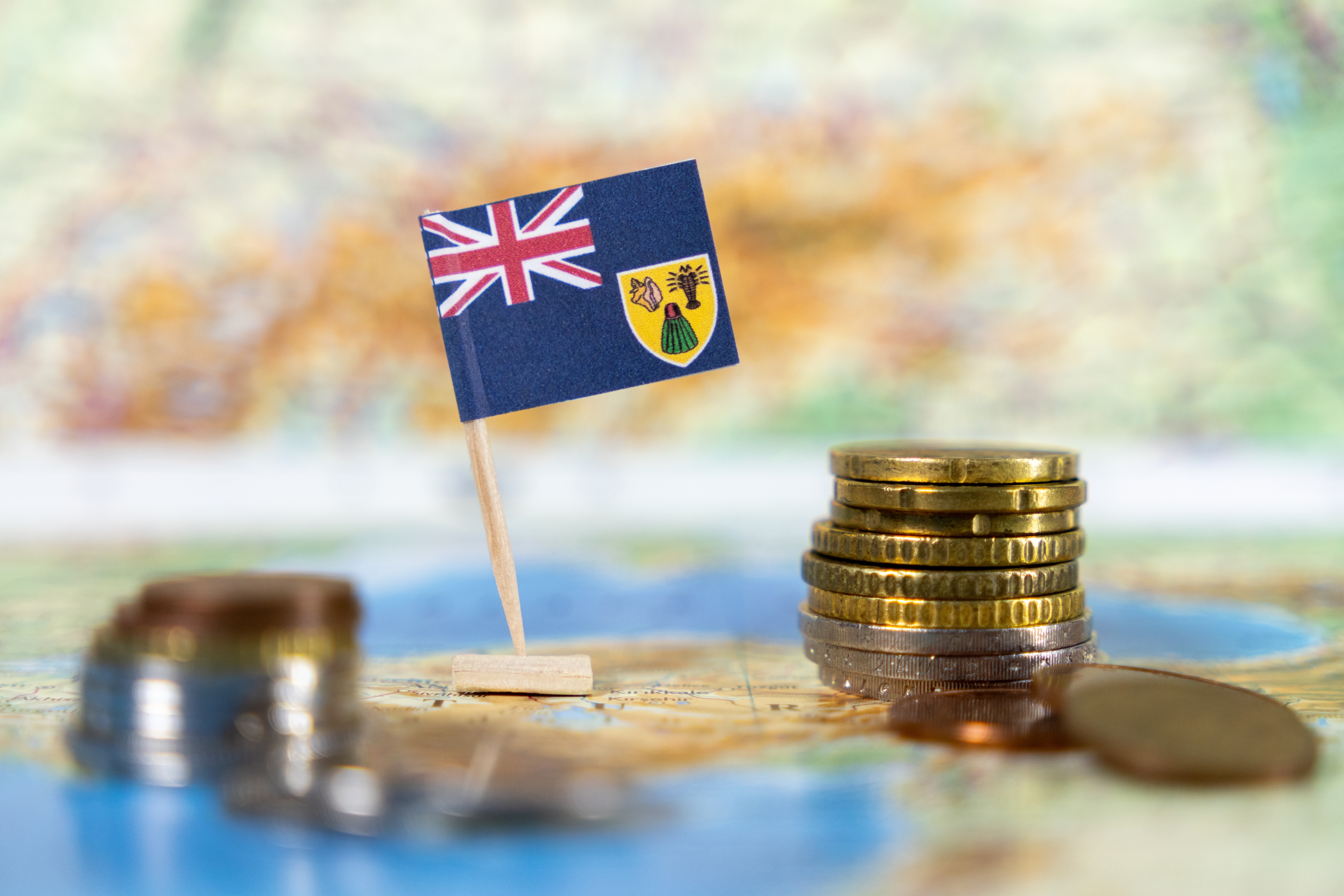 Turks and Caicos flag with coins on map