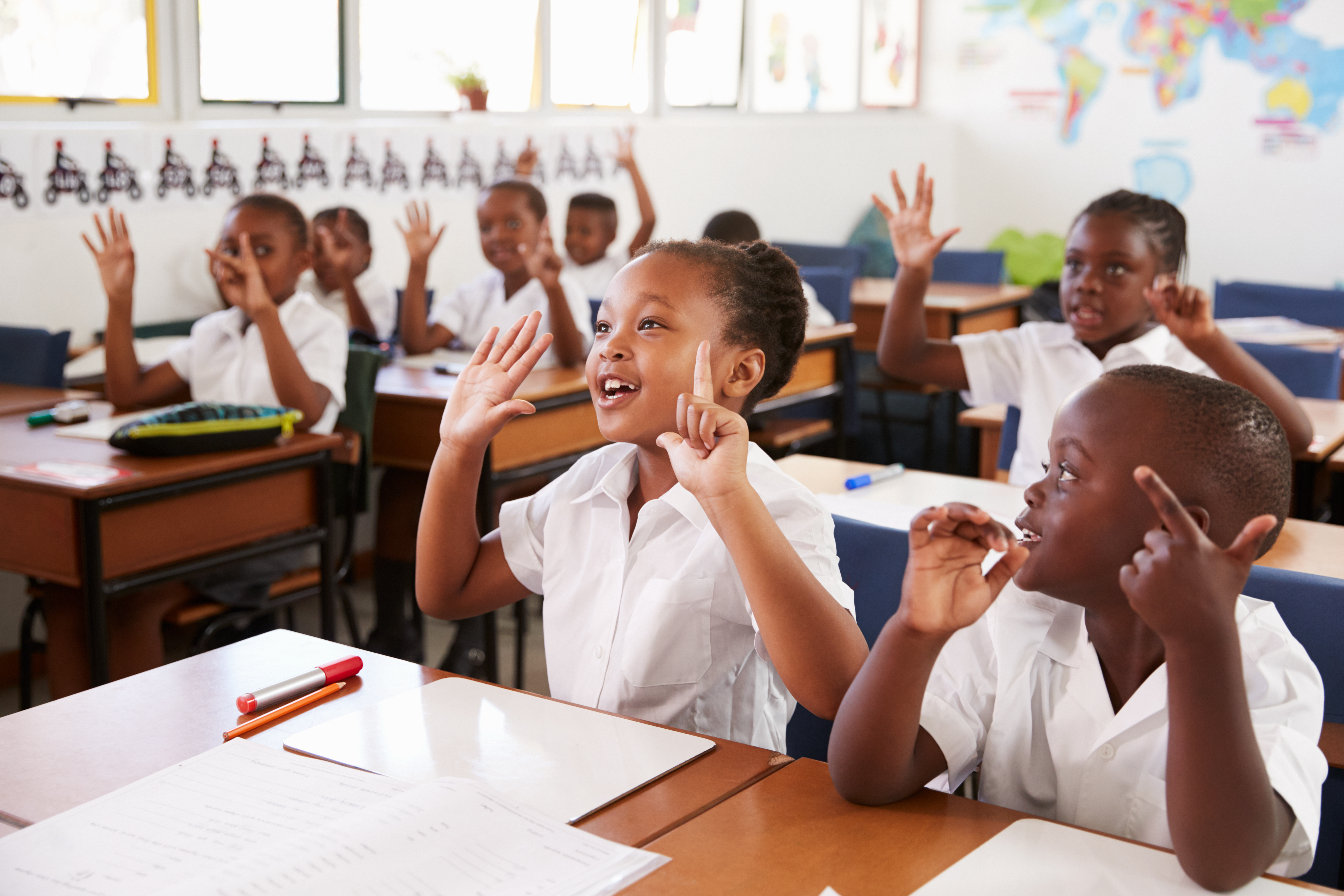 Kids showing hands during a lesson at school 