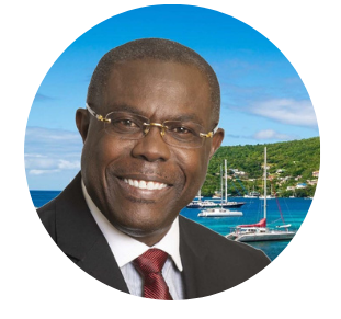 Image of a smiling Isaac Solomon in a suit and red tie against a backdrop of a Caribbean coastal scene with turquoise waters, sailboats, and green hills.