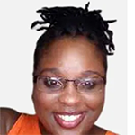 young smiling black female in glasses wearing orange sleeveless dress