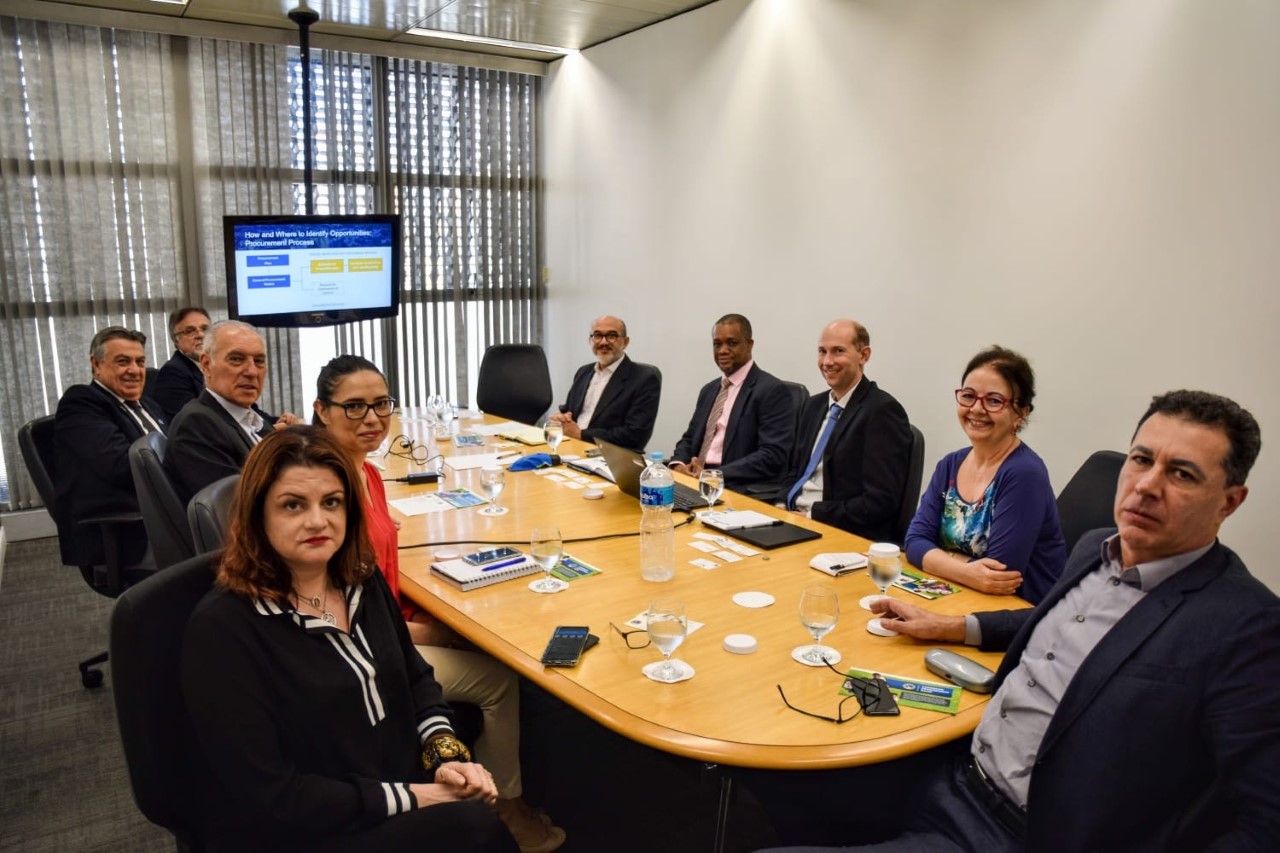 CDb and Brazil representatives sit at desk