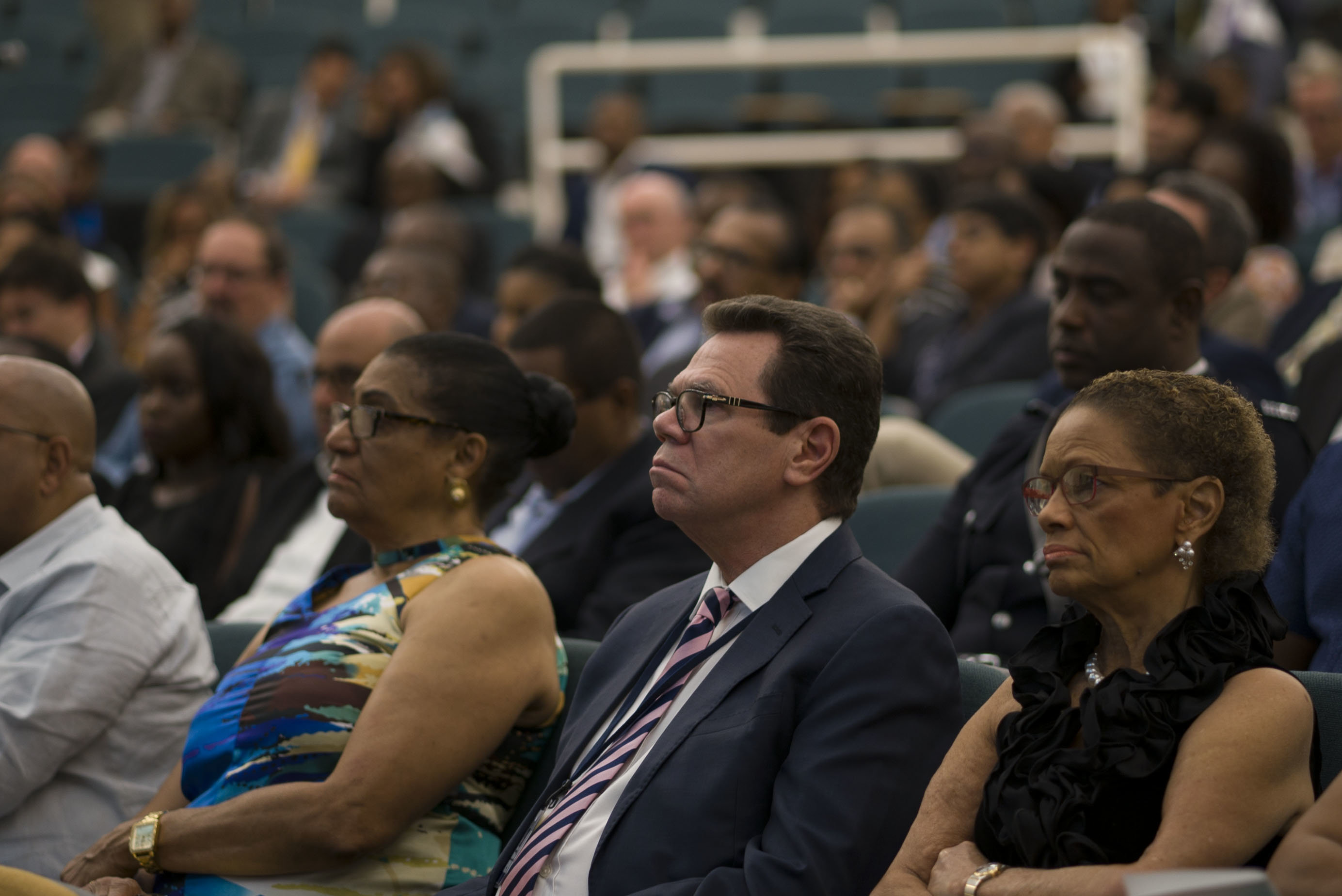 (L-R) Her Excellency Dr. Cécile La Grenade, Governor General, Grenada; Dr. Wm. Warren Smith, President, Caribbean Development Bank and his wife Dr. Anne-Marie Irvine, listen to Mark Pelling as he delivers the 9th William G. Demas Memorial Lecture on May 29 in Grenada.