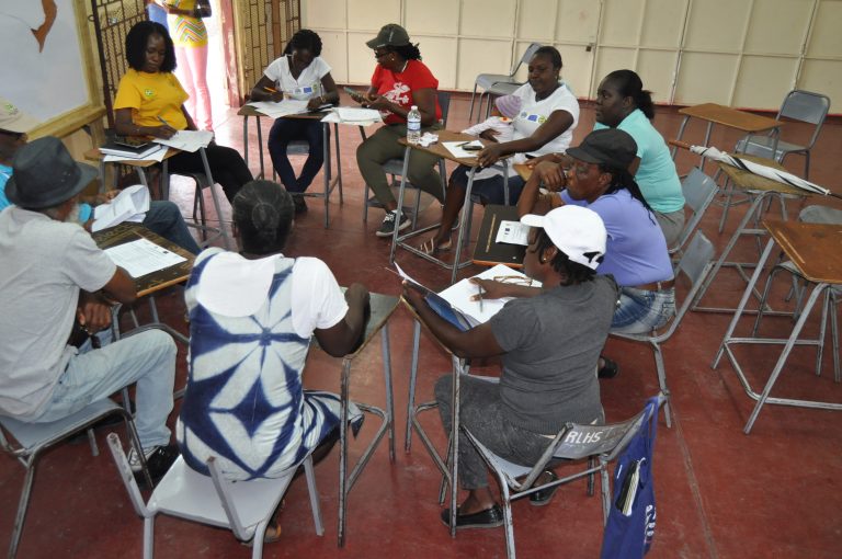 participants at a community meeting seated in a circle