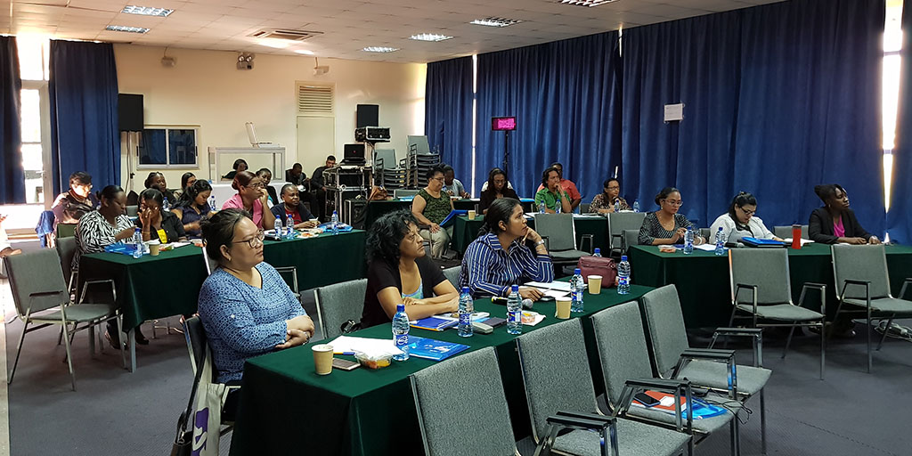 seated audience members pay close attention to presenter