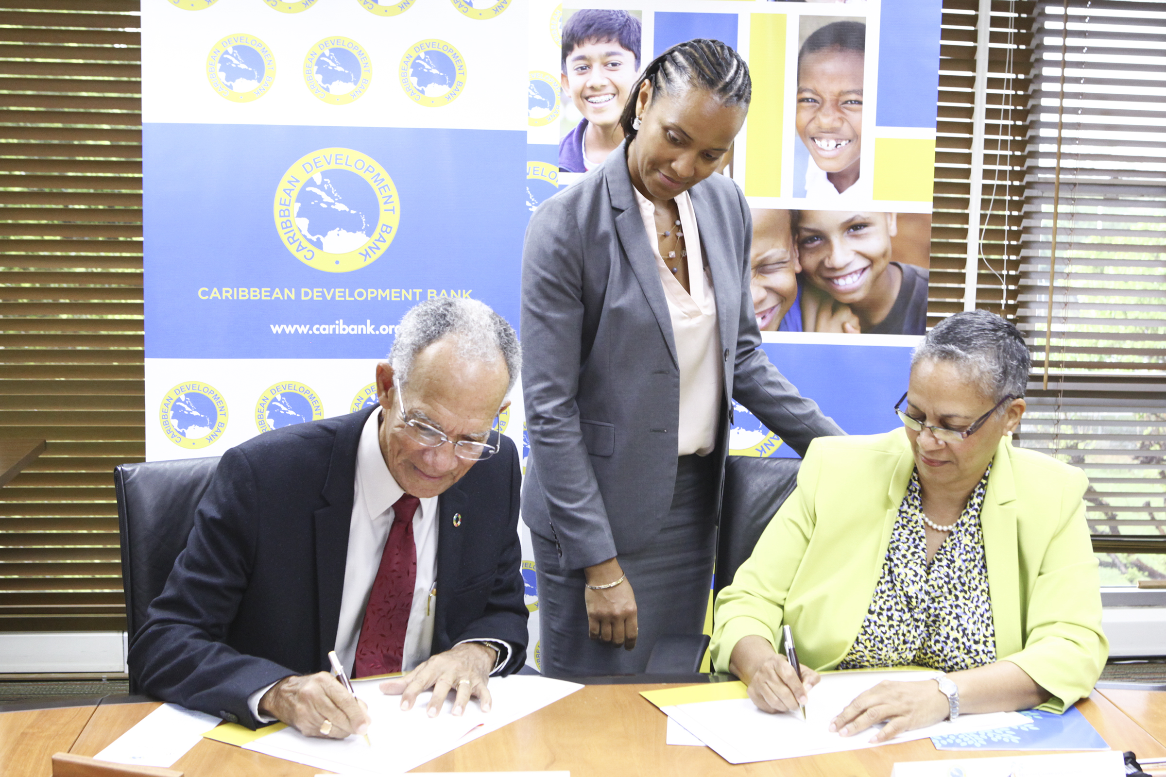 Sir. Trevor Hassell, President of the HCC (left) and Monica La Bennett, Vice-President (Operations), CDB (right) sign the grant agreement in the presence of CDB’s Deputy General Counsel, Nicole Jordan (centre).