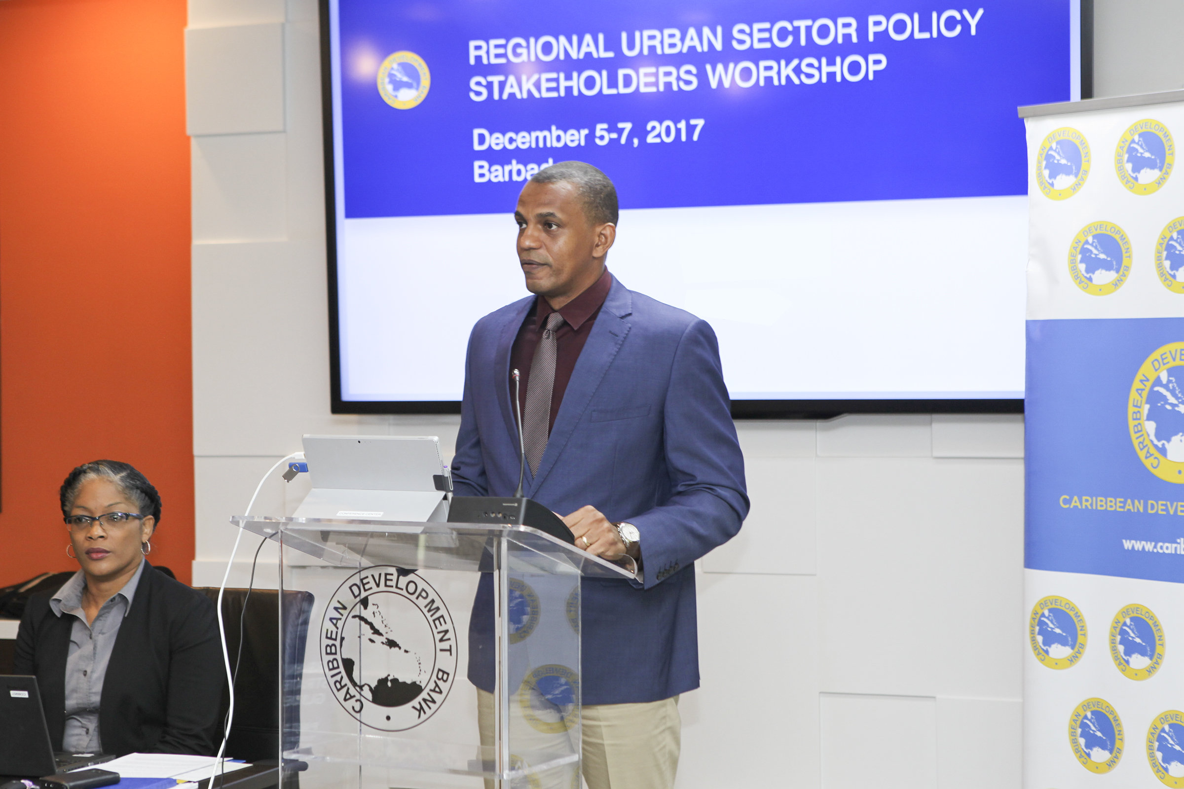 Daniel Best, Director of Projects, CDB, speaks at the opening of the Regional Urban Sector Policy Stakeholders Workshop on December 5, 2017. Looking on is Sharon Griffith, Operations Officer, CDB.