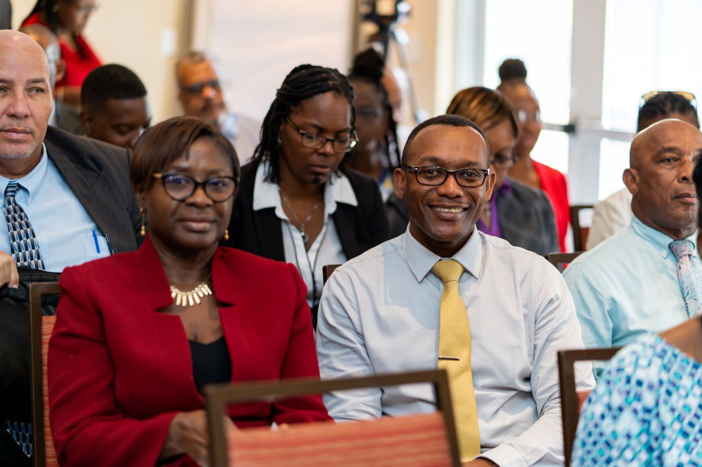 Smiling woman and man seated facing camera.