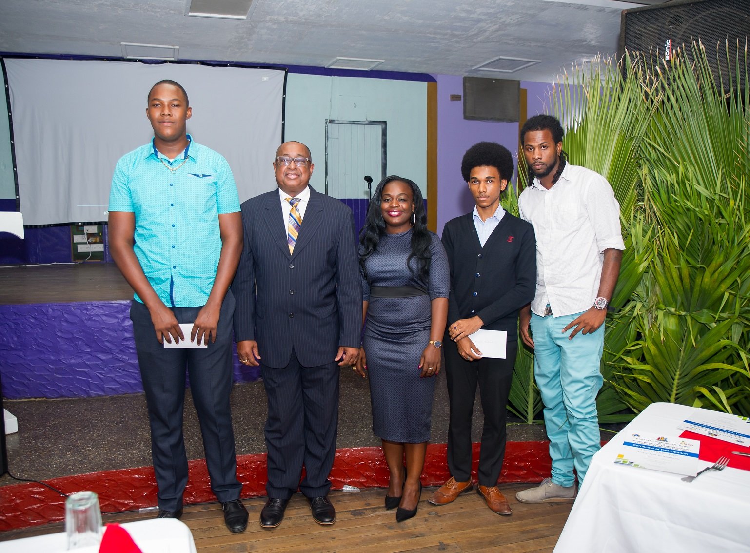 L to R: Jhavaughn Gludd, first-prize winner; Volville Forsythe, Assistant Bank Secretary, CDB; Hon. Kate Lewis, Minister within the Ministry of Youth Development, Sports, Culture and the Arts; Brandon Brathwaite, second-prize winner and Lyndon Pope, third-prize winner at the VYBZING Closing Ceremony.