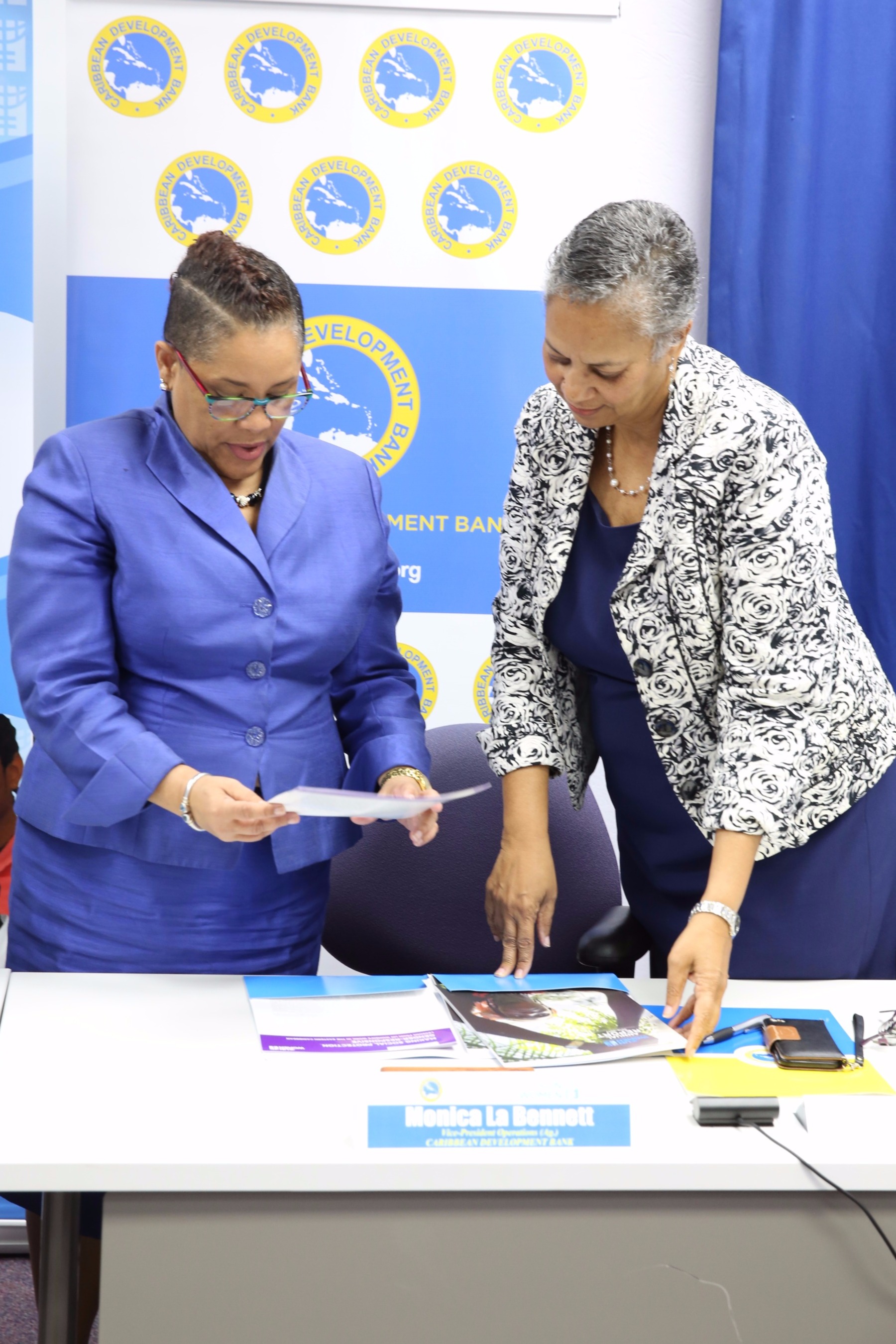 Ms. M. Alison McLean, Representative, UN Women Multi-Country Office – Caribbean and Monica La Bennett, Acting Vice-President (Operations), CDB, review the agreement on July 27, 2017.