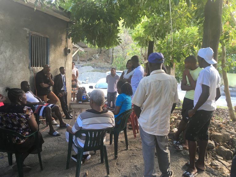 community meeting under the tree