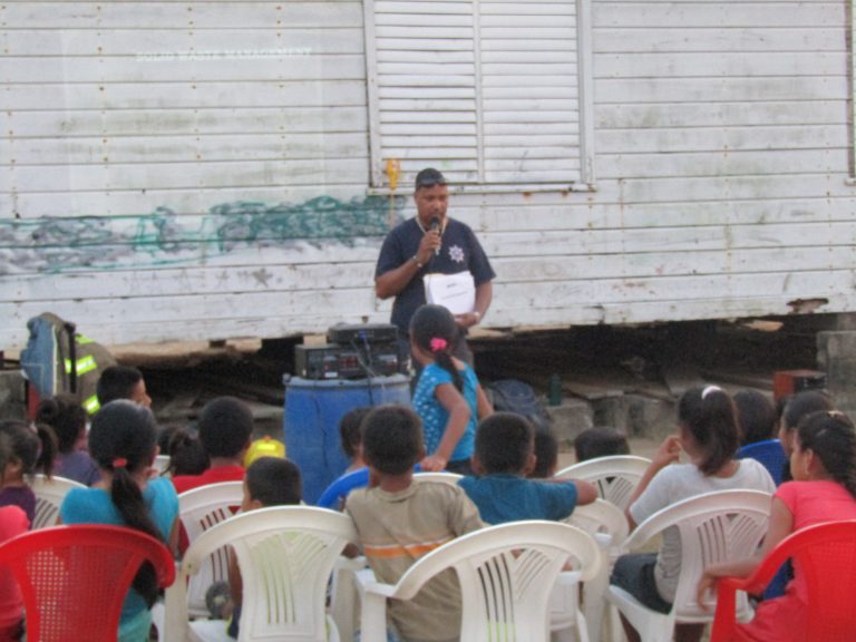 presenter speaking in front of a seated crowd