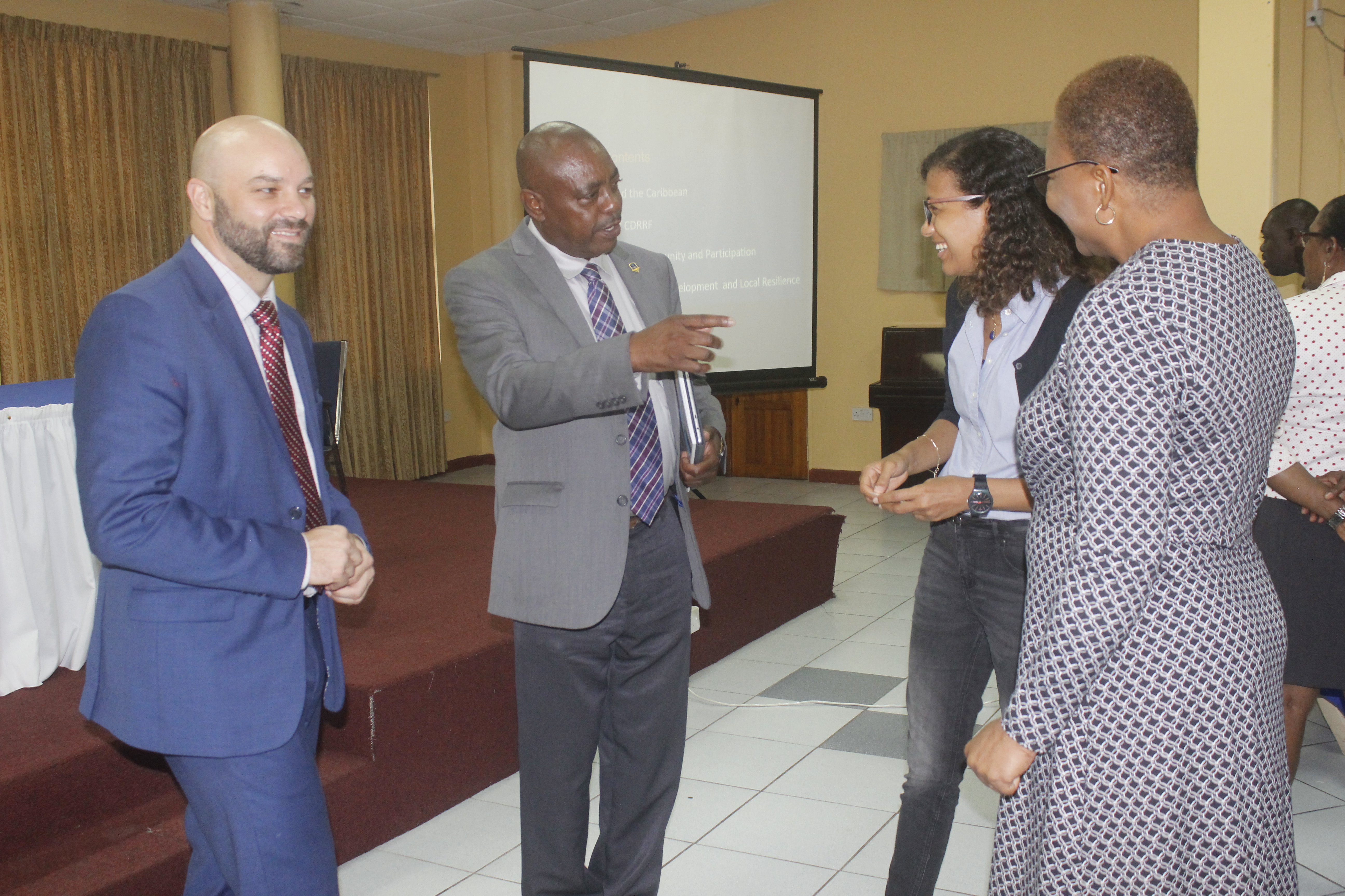 photo of two men and two ladies standing talking