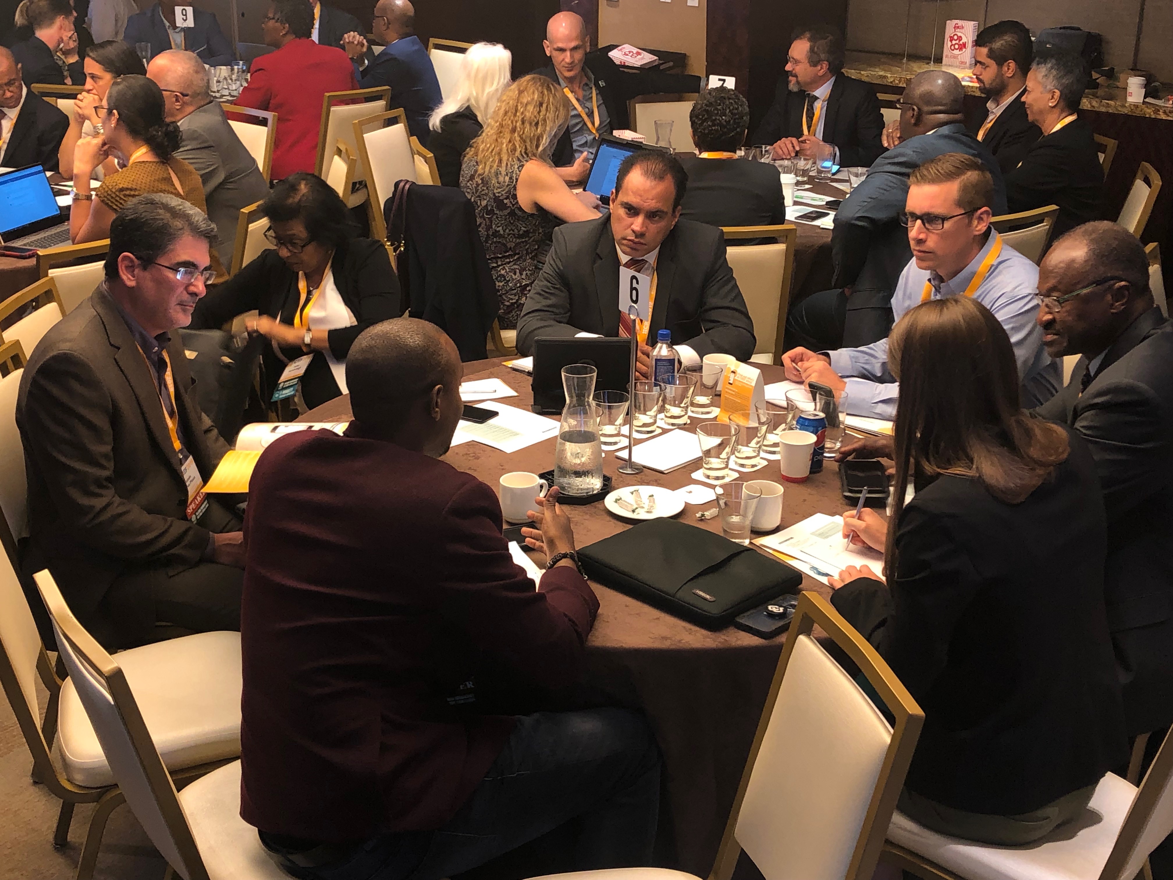 A group of professionals sitting at a roundtable having a discussion.